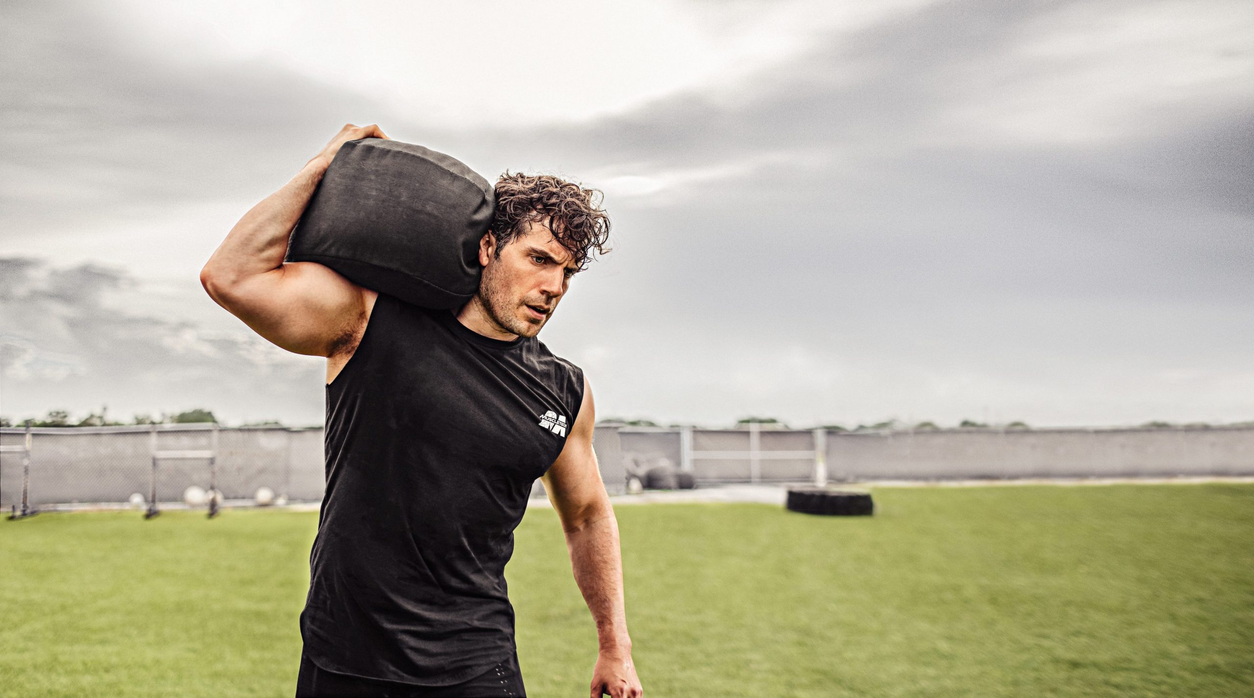 Henry Cavill carrying a weight on his shoulder.