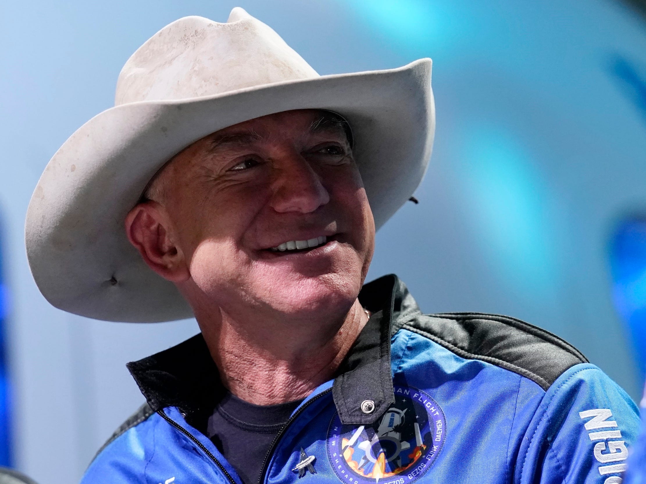 Jeff Bezos wearing cowboy hat and space suit at Blue Origin rocket launch