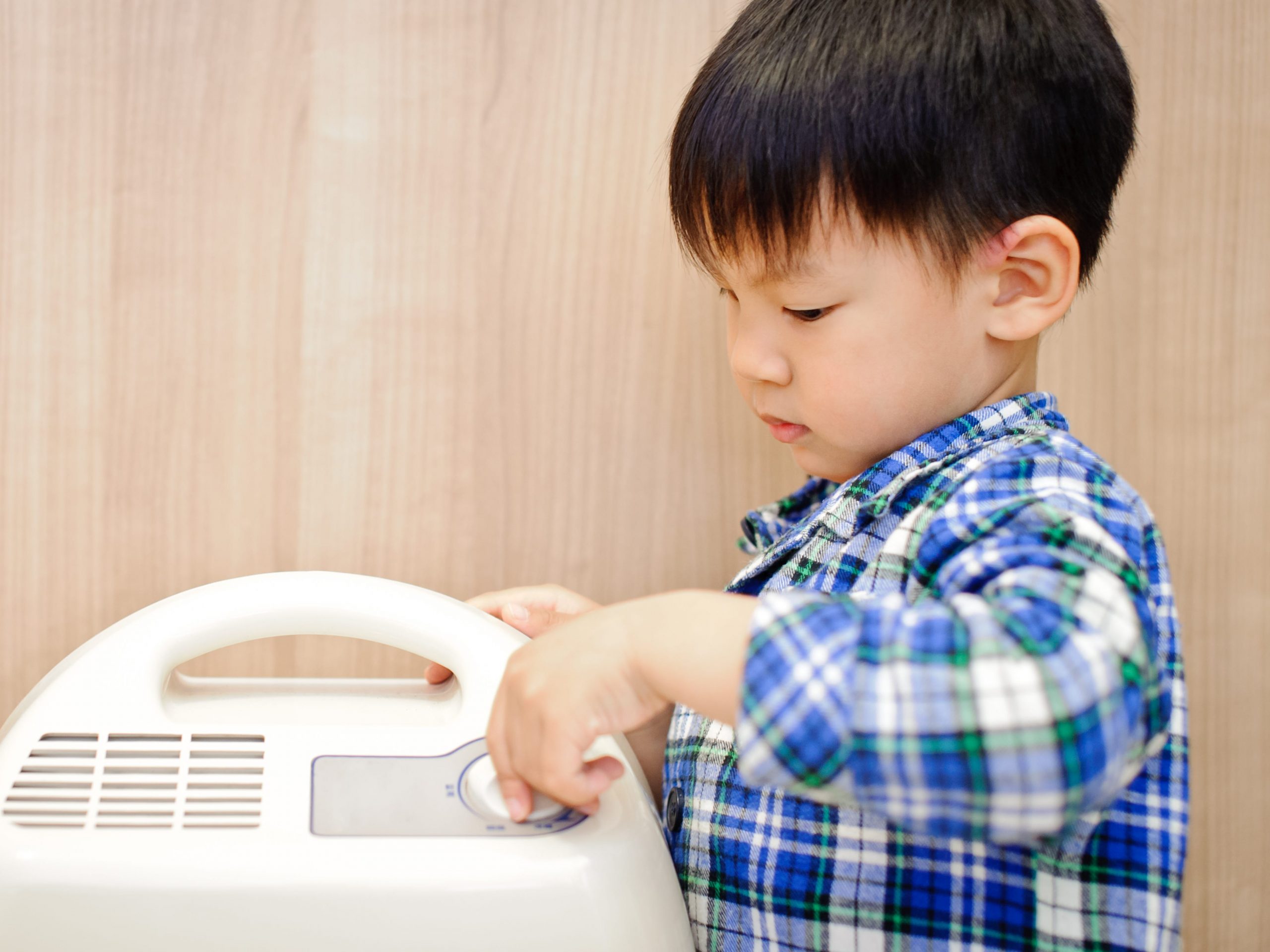 boy next to dehumidifier