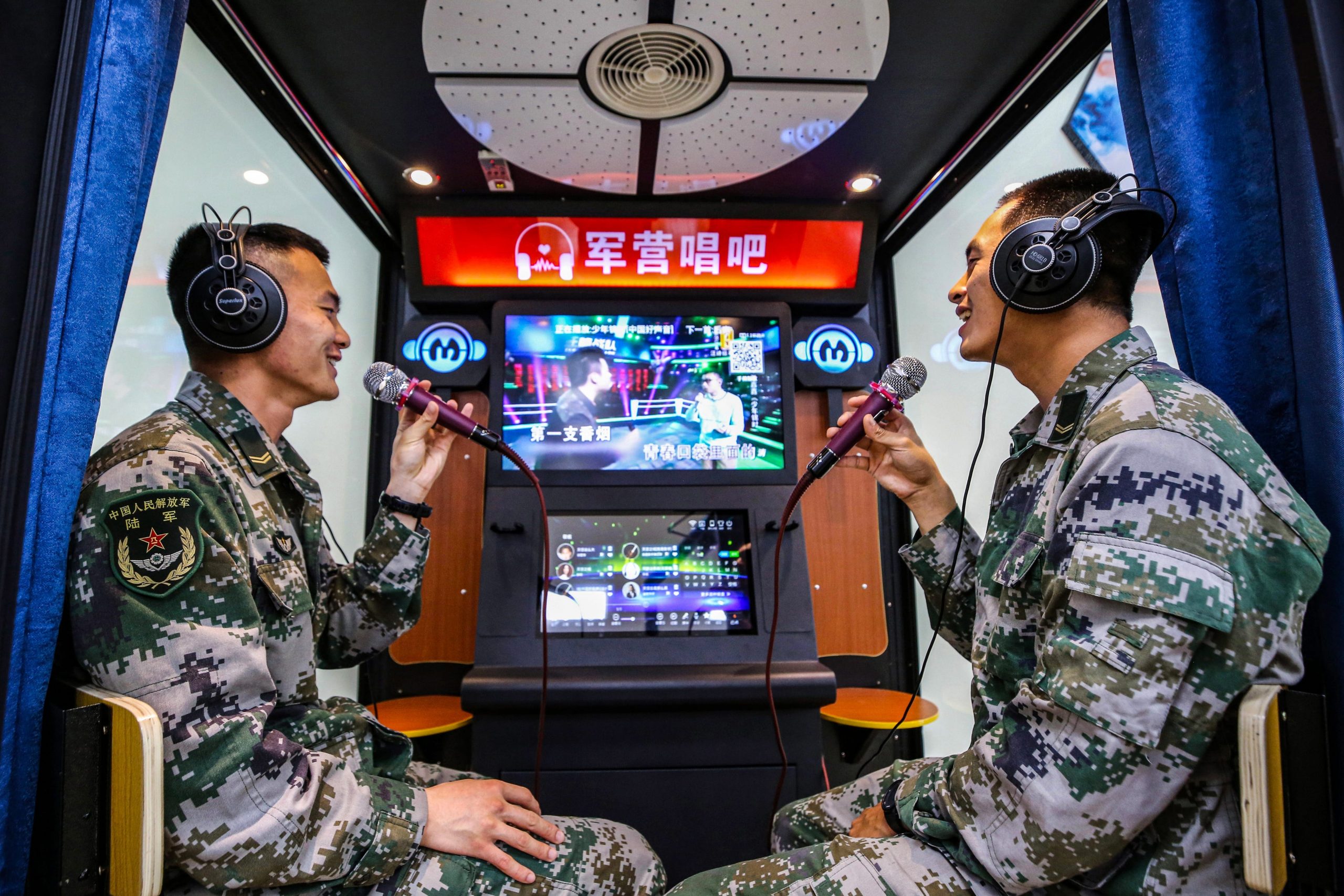 Chinese soldiers singing at a karaoke booth at a military barracks in Jiangsu Province.