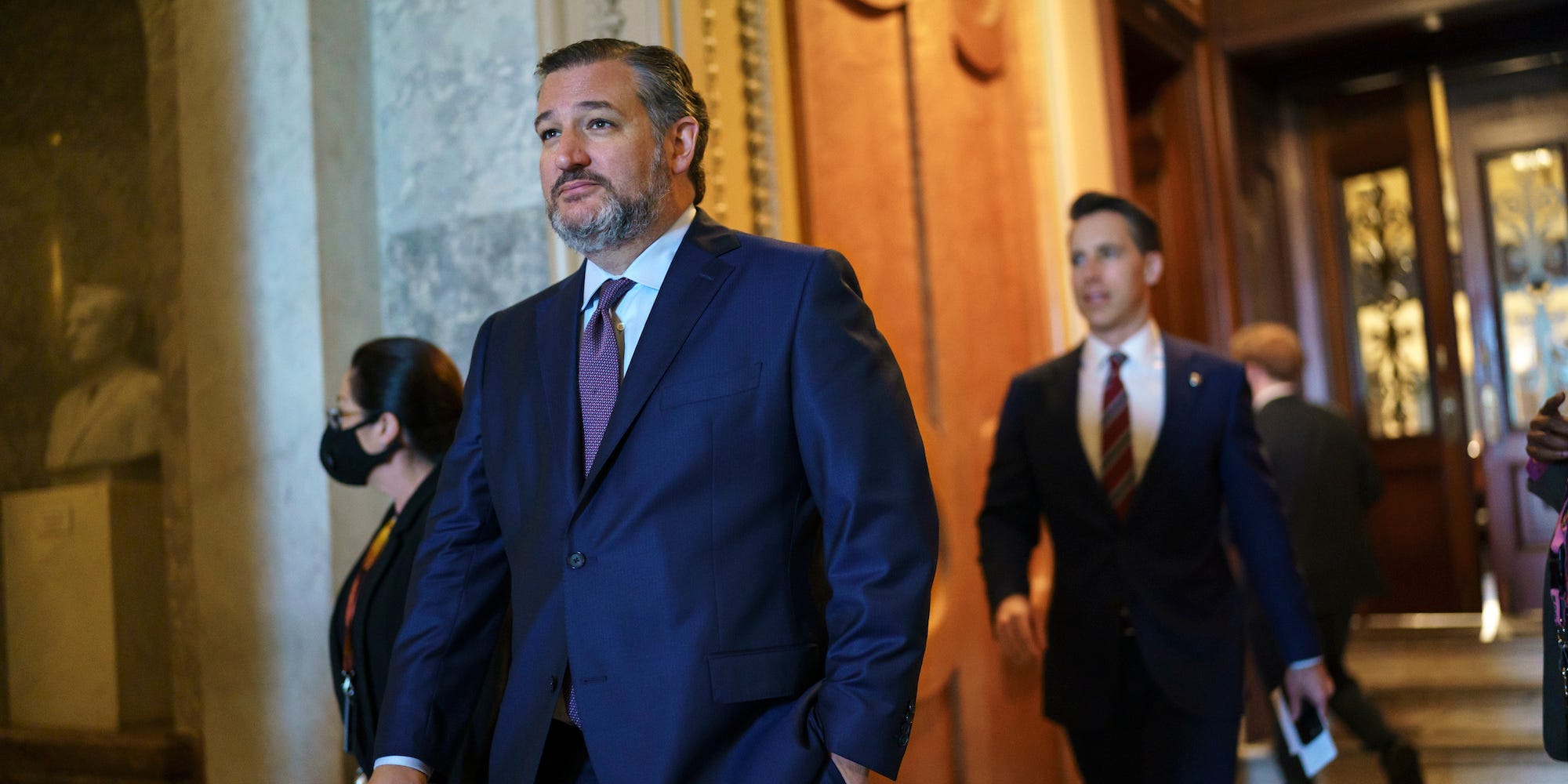 Sen. Ted Cruz, R-Texas, followed by Sen. Josh Hawley, R-Mo., leaves the chamber during the non-stop voting session on President Joe Biden's top domestic policy ambitions, at the Capitol in Washington, Tuesday, Aug. 10, 2021.