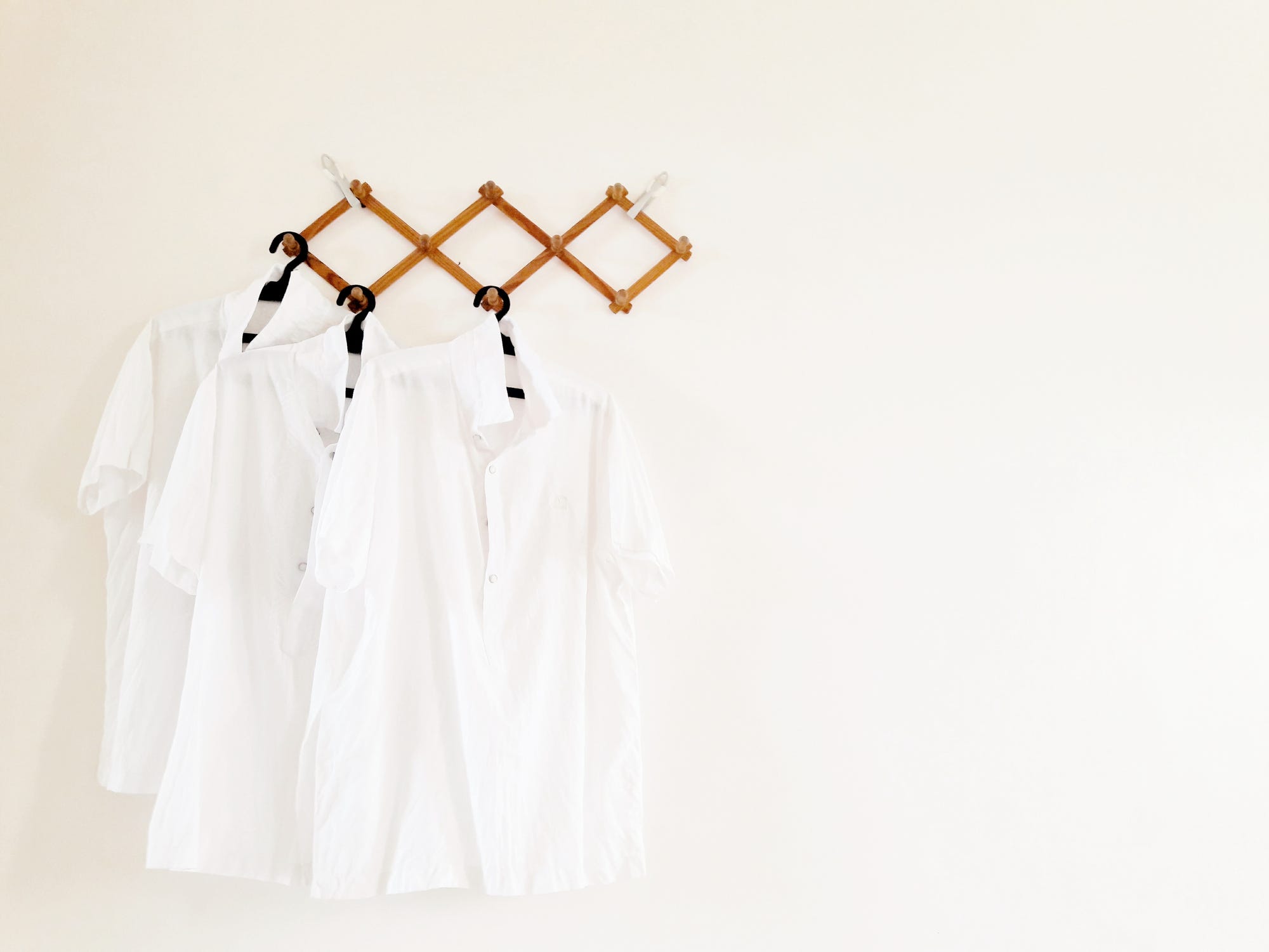 White shirts hanging on a hanging rack.