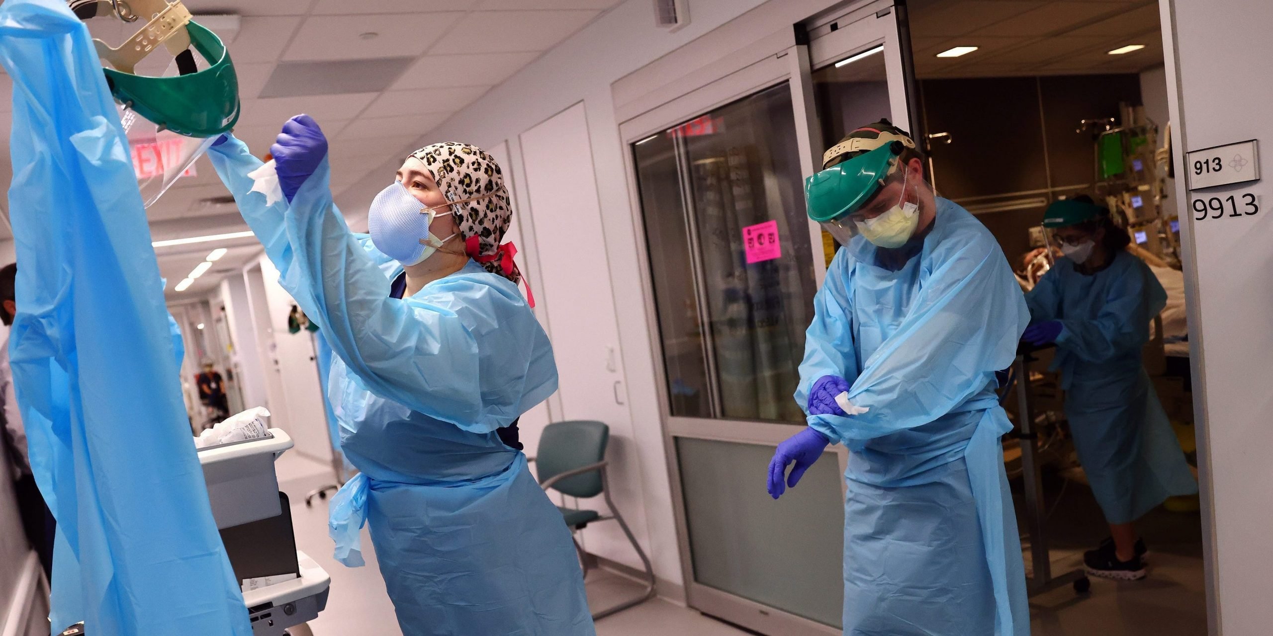 Clinicians depart a patient room after re-positioning a COVID-19 patient into the supine position in the Intensive Care Unit (ICU) at Lake Charles Memorial Hospital on August 10, 2021 in Lake Charles, Louisiana.