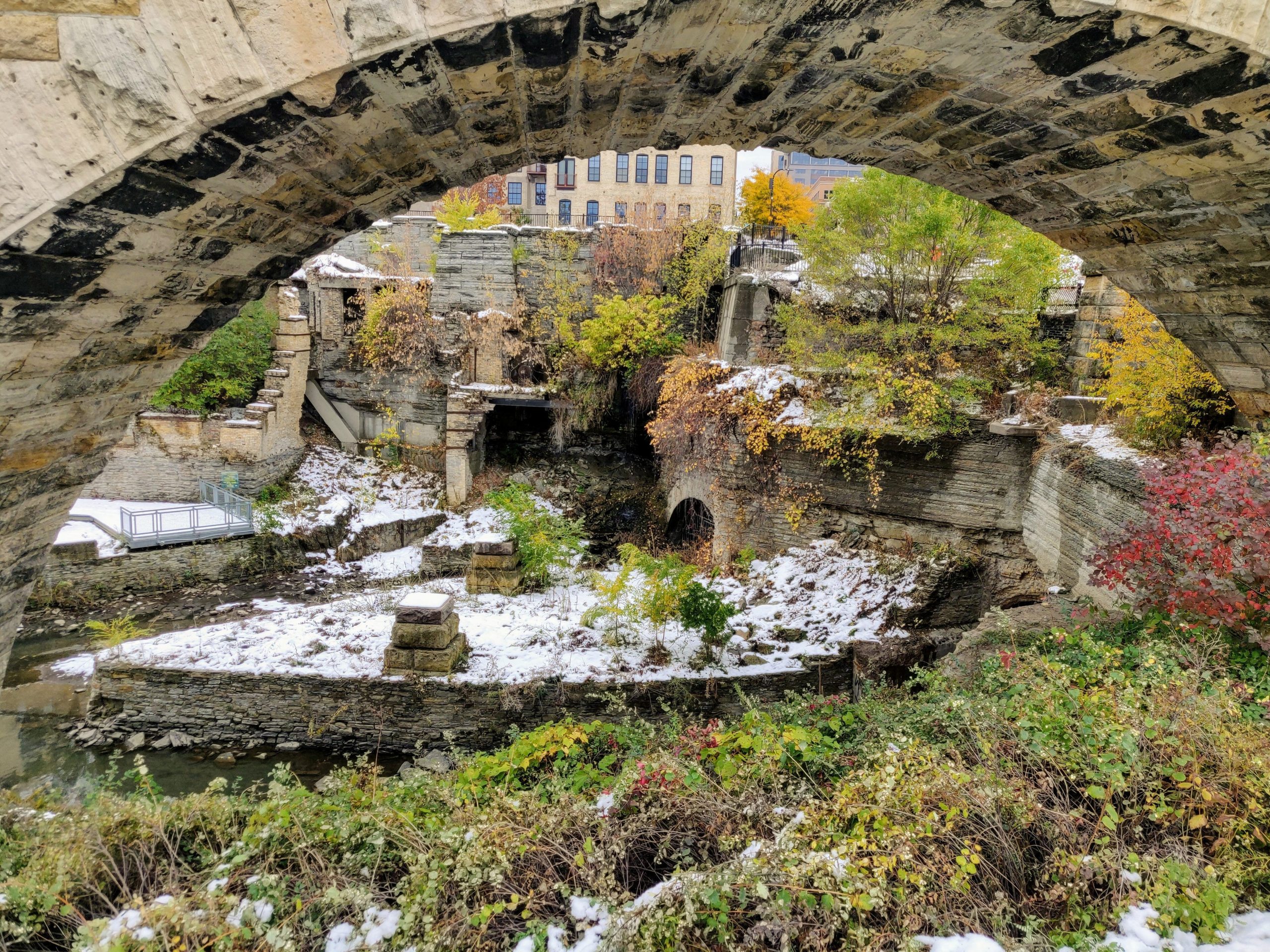 View into green Mill Ruins Park through arch in Minneapolis