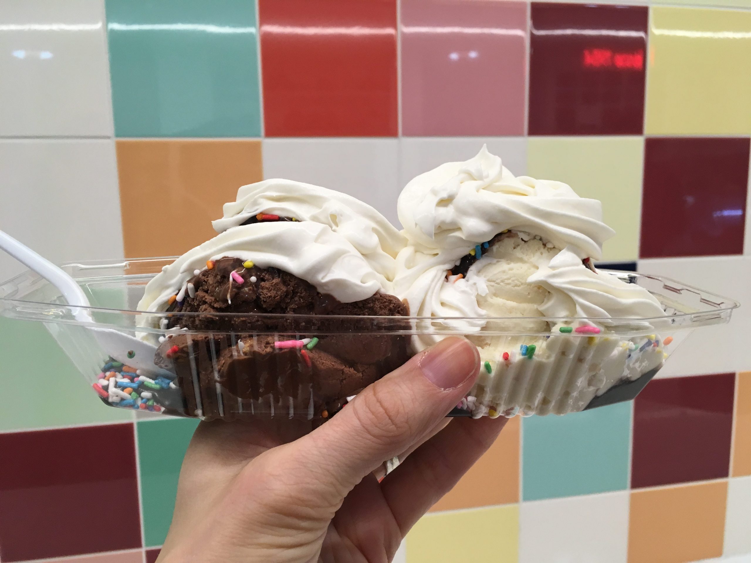 Ice cream scoops against a colorful tiled wall from Sebastian Joes in Minneapolis