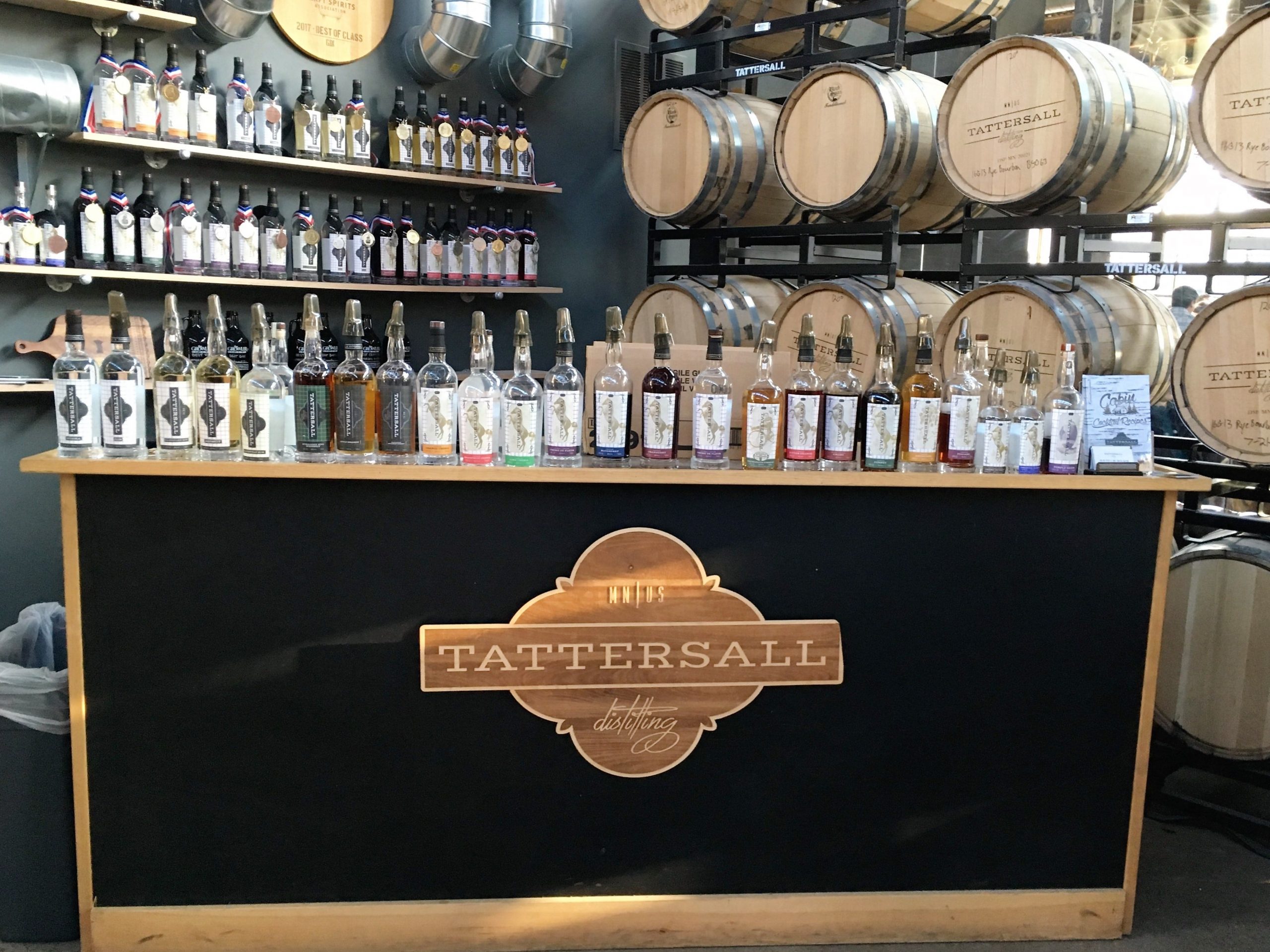 Tattersail's spirits lined up on a black and gold bar in Minneapolis