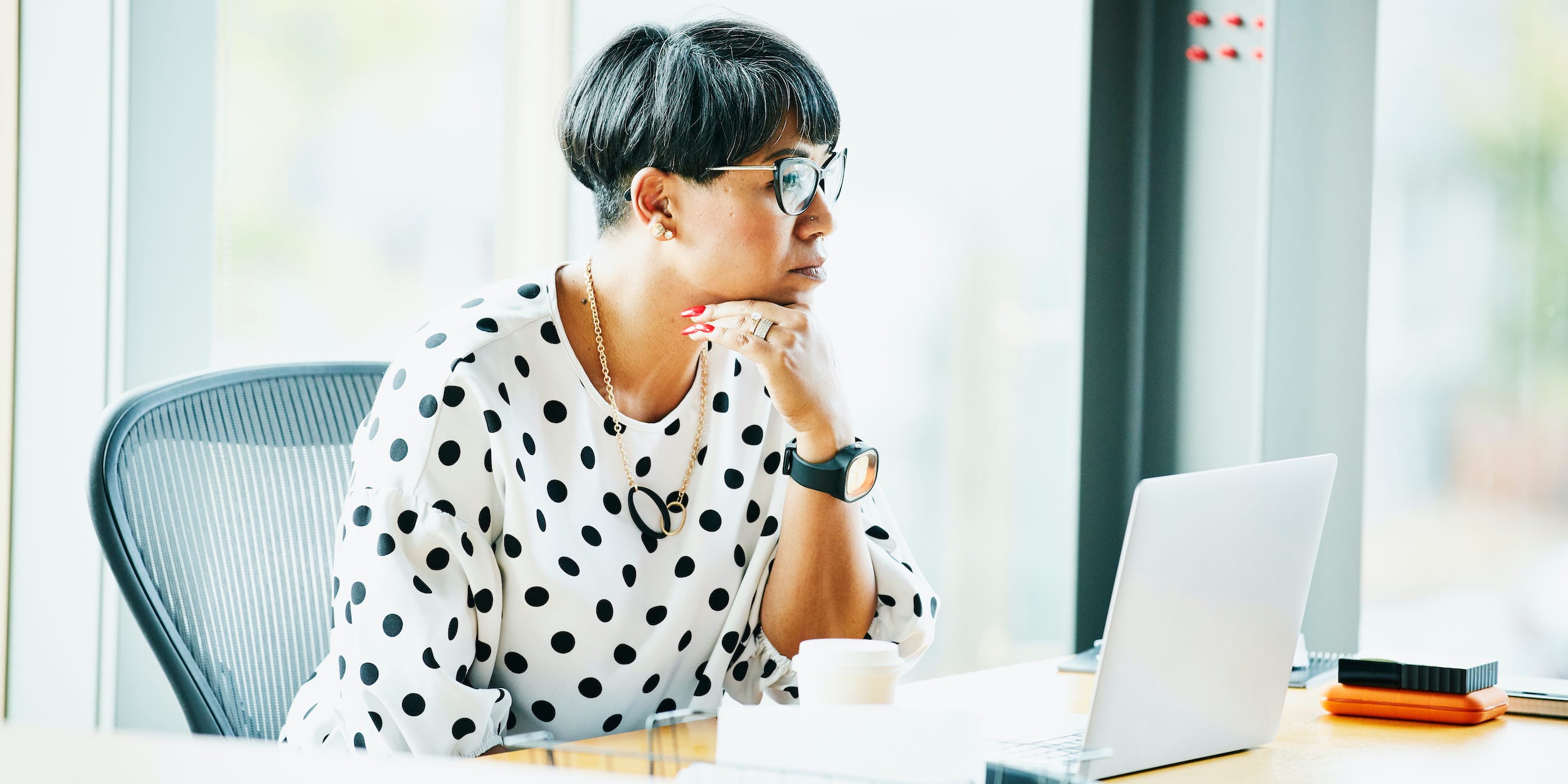 Business professional looking at laptop working at desk