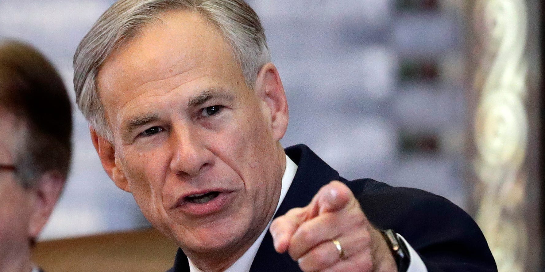 Texas Governor Greg Abbot points at the camera with a stern expression