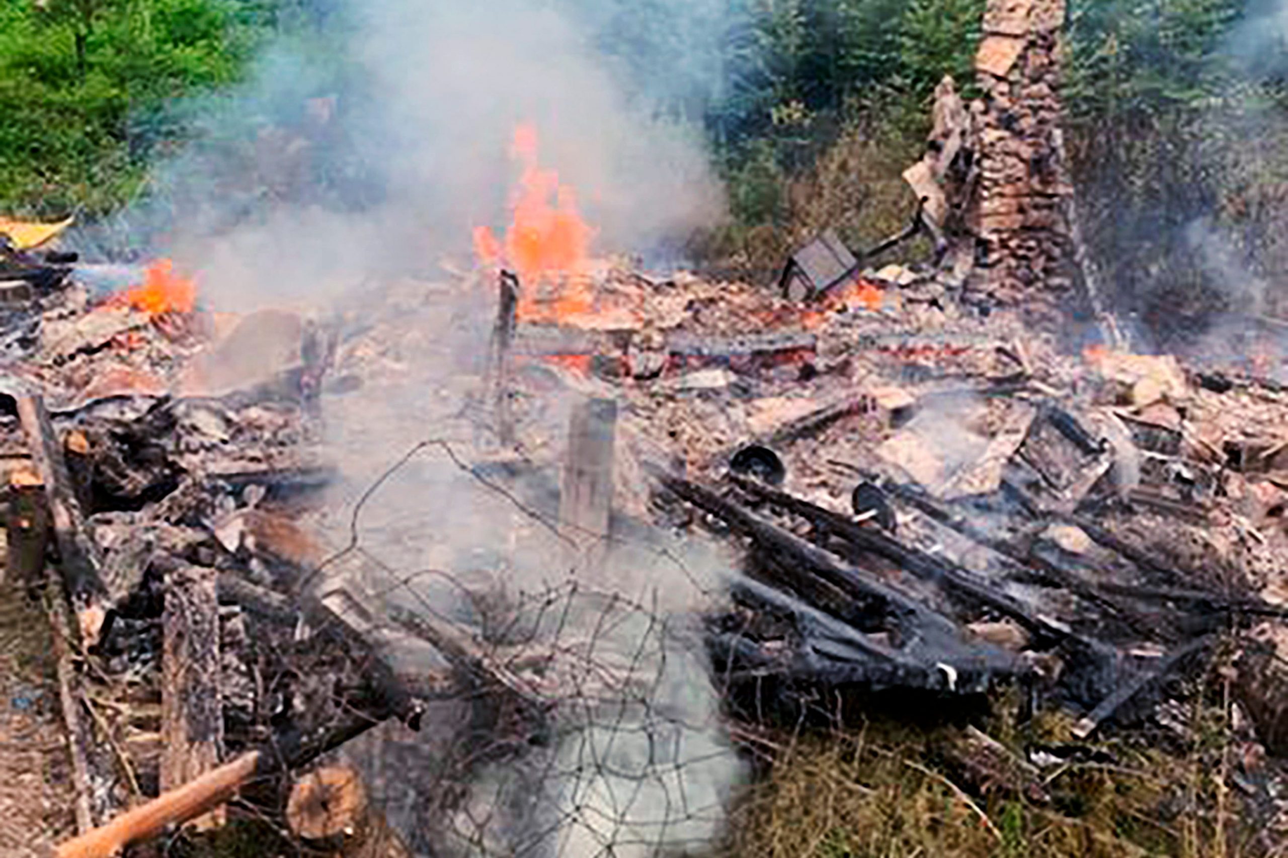 A photo of fire and smoke burning down David Lidstone's makeshift cabin.