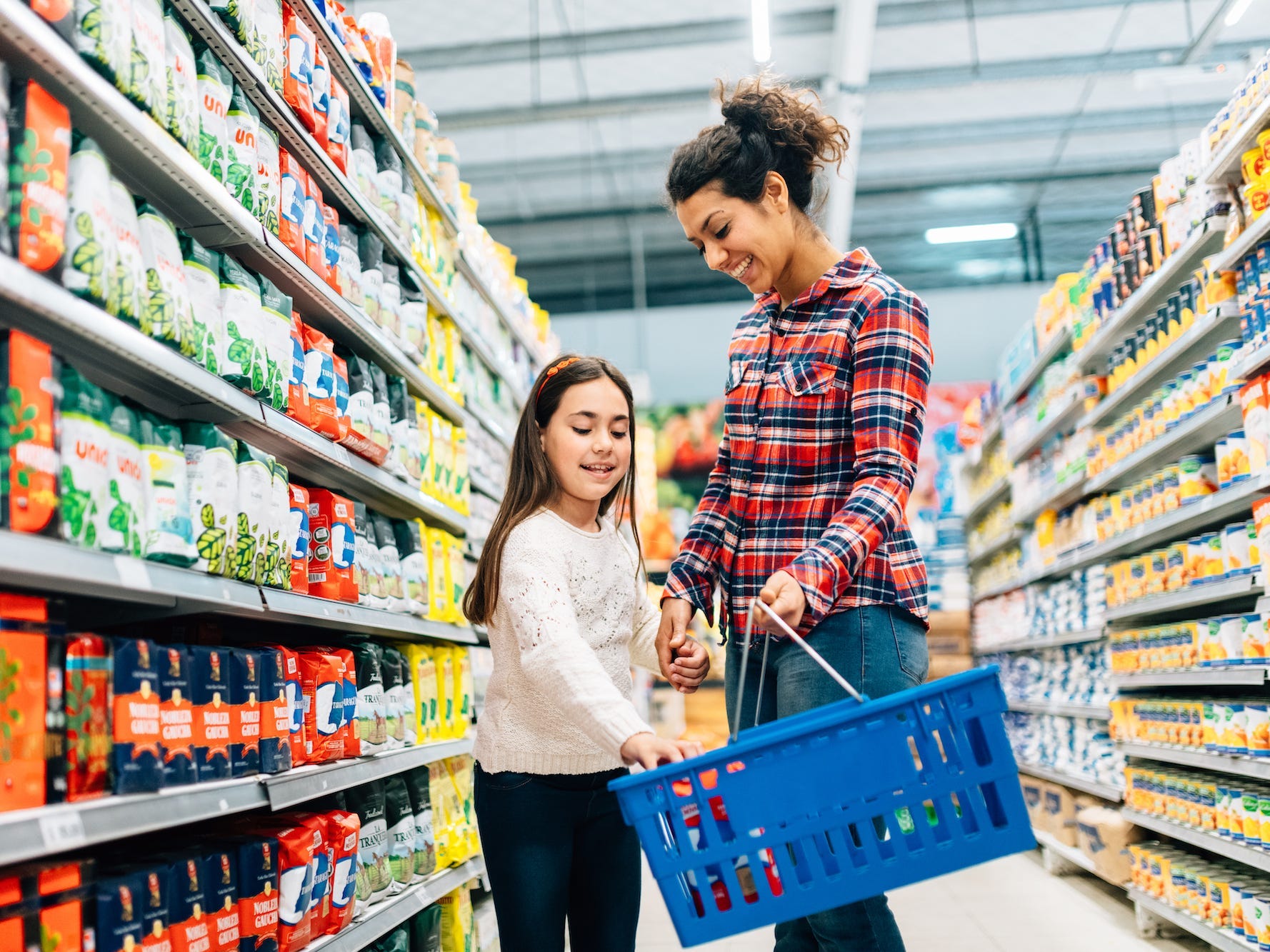 Mother and daughter shopping in supermarket