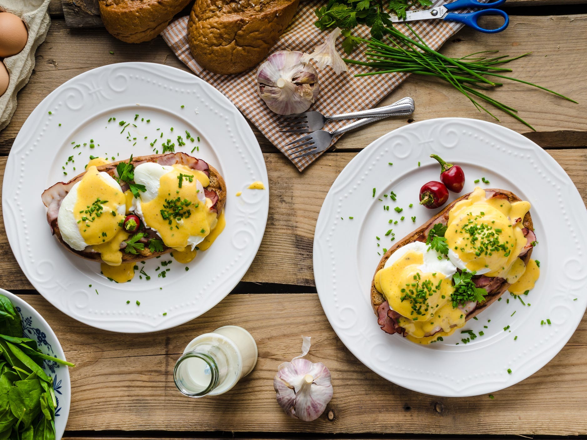 Two plates of eggs benedict viewed from above