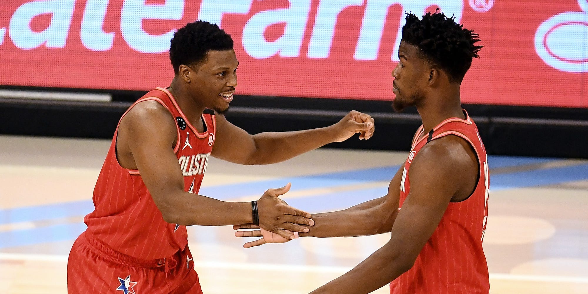 Kyle Lowry and Jimmy Butler high-five during the 2020 NBA All-Star Game.