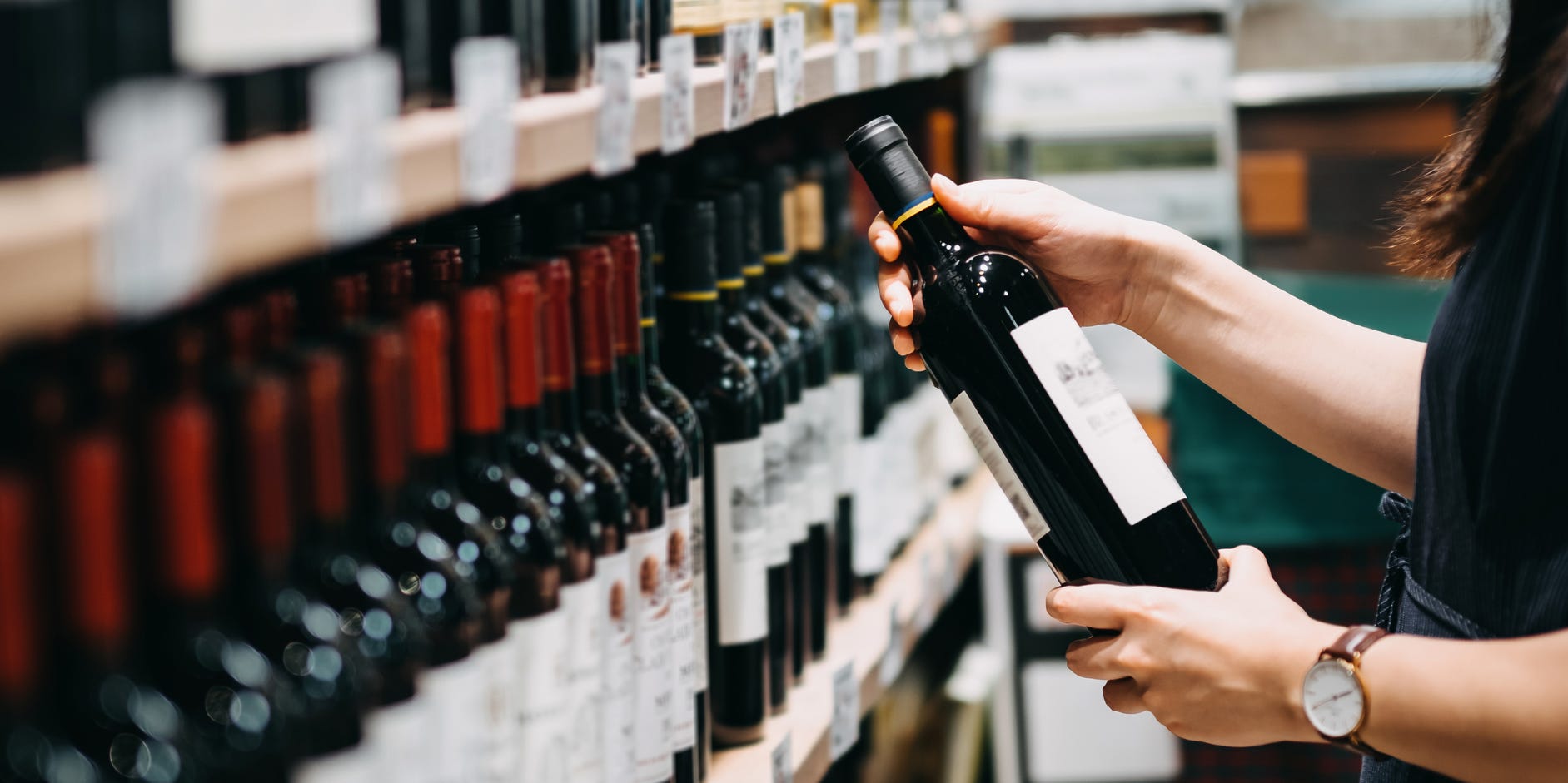 Someone looking through a selection of wines.