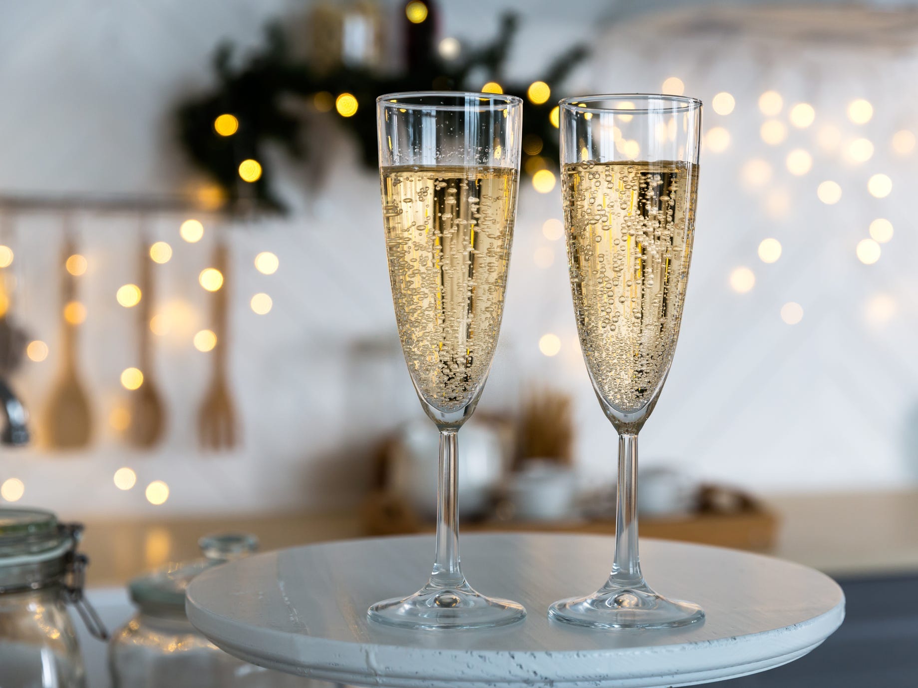 Two glasses of champagne on a tray.