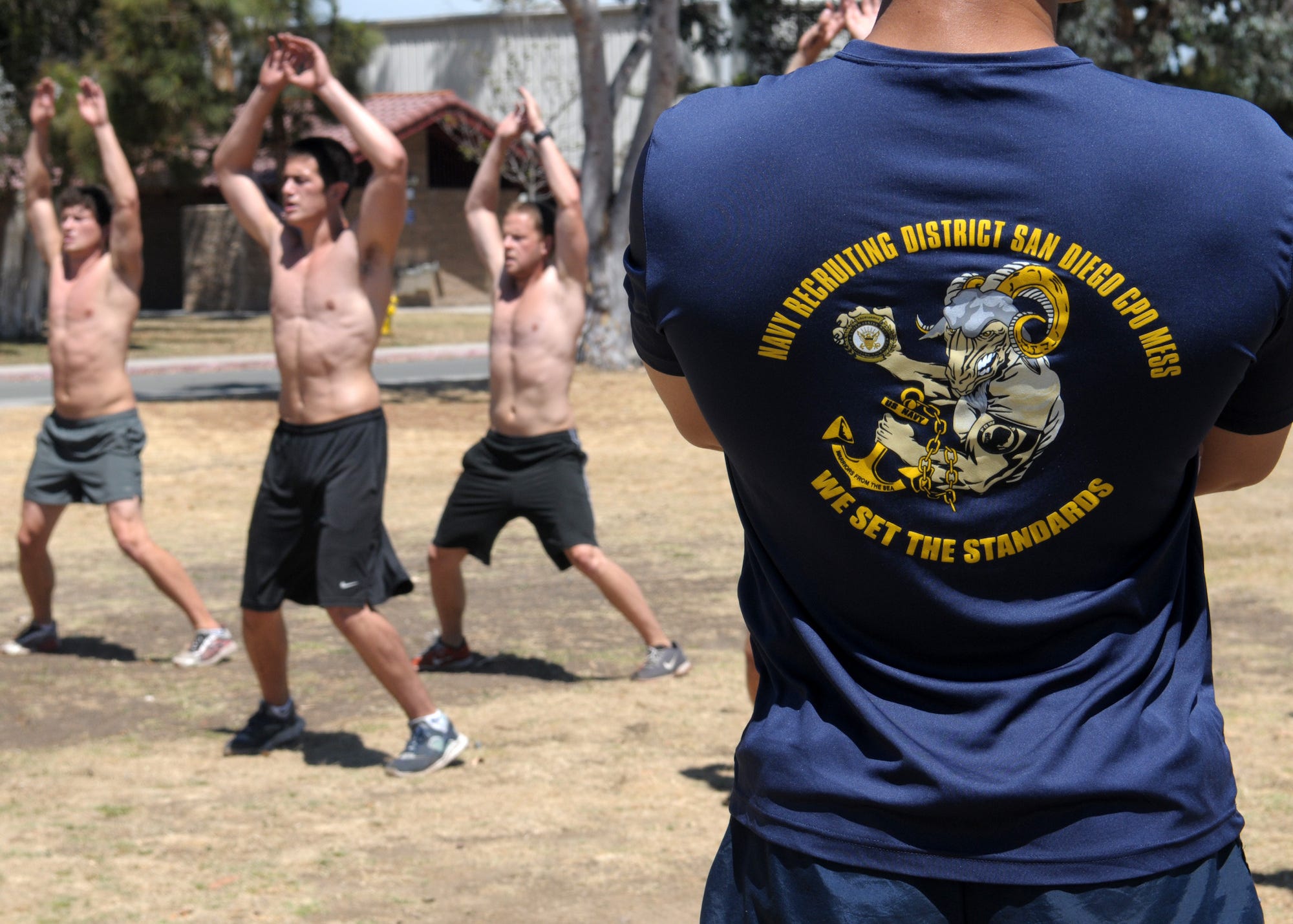 Naval Special Warfare candidates do jumping jacks