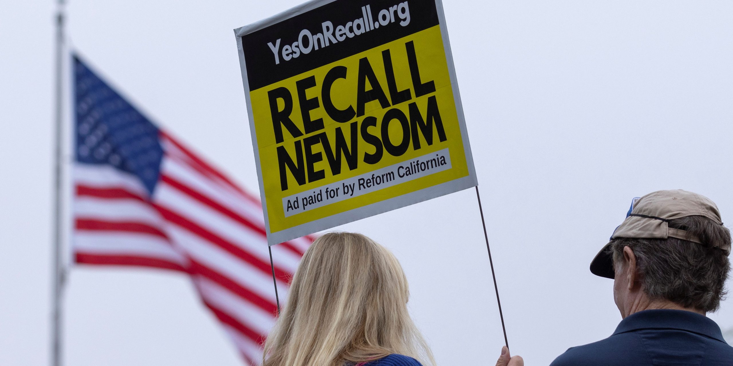 Supporters of the recall campaign of California governor Gavin Newsom holding a sign