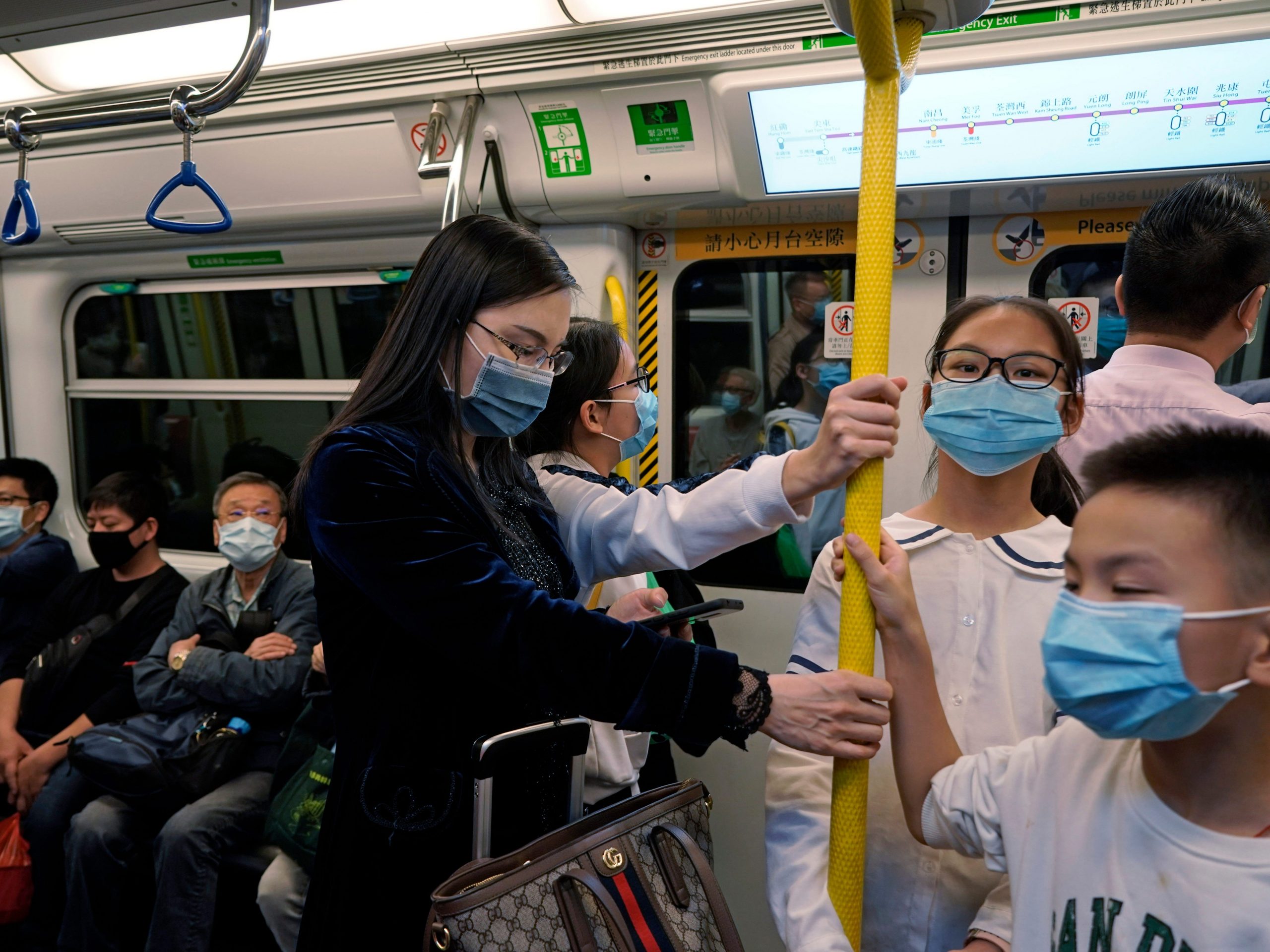 Passengers wear protective face masks on the subway in Hong Kong, Thursday, January 23, 2020.