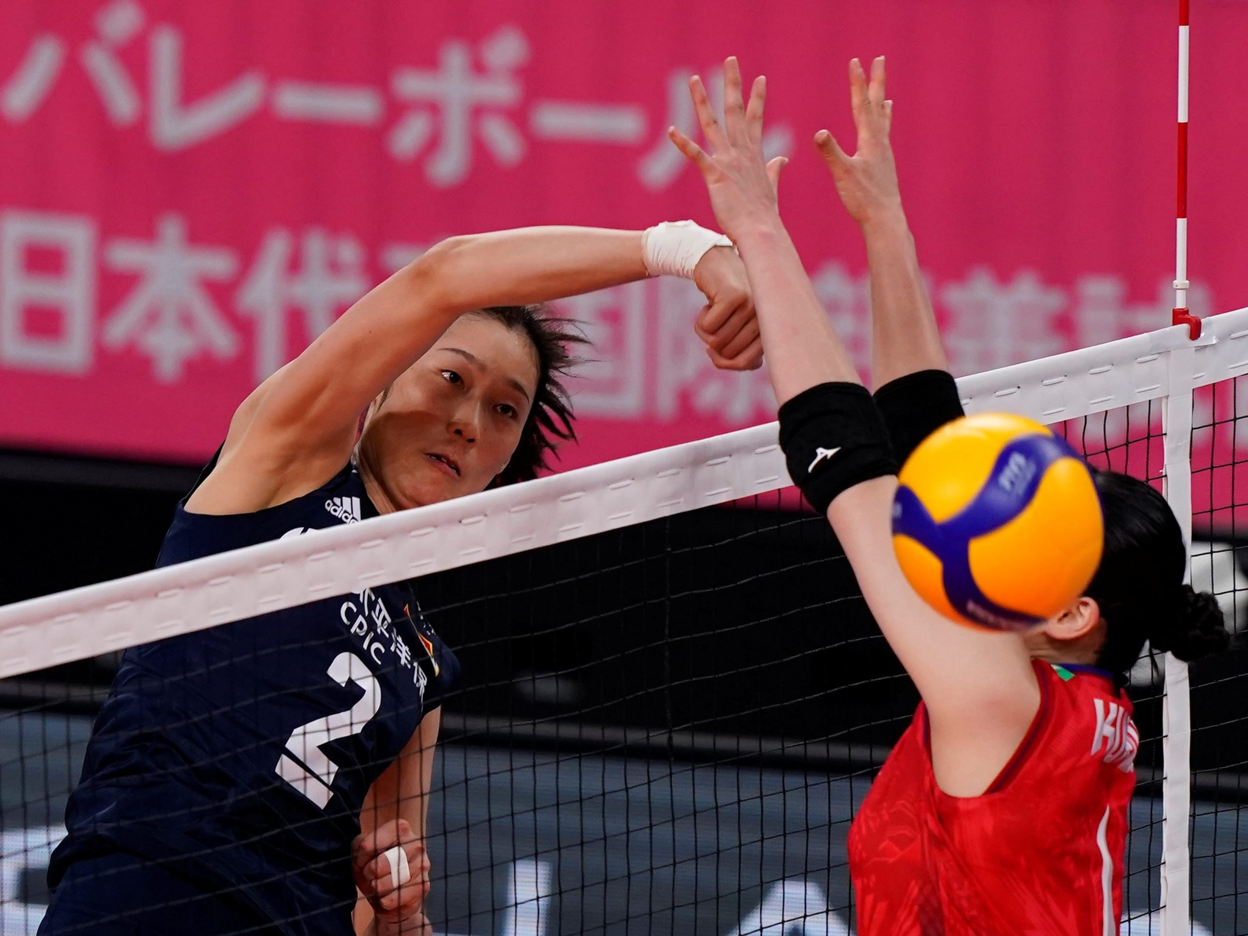 China's Zhu Ting attacks against Ai Kurogo during the women's volleyball match between China and Japan