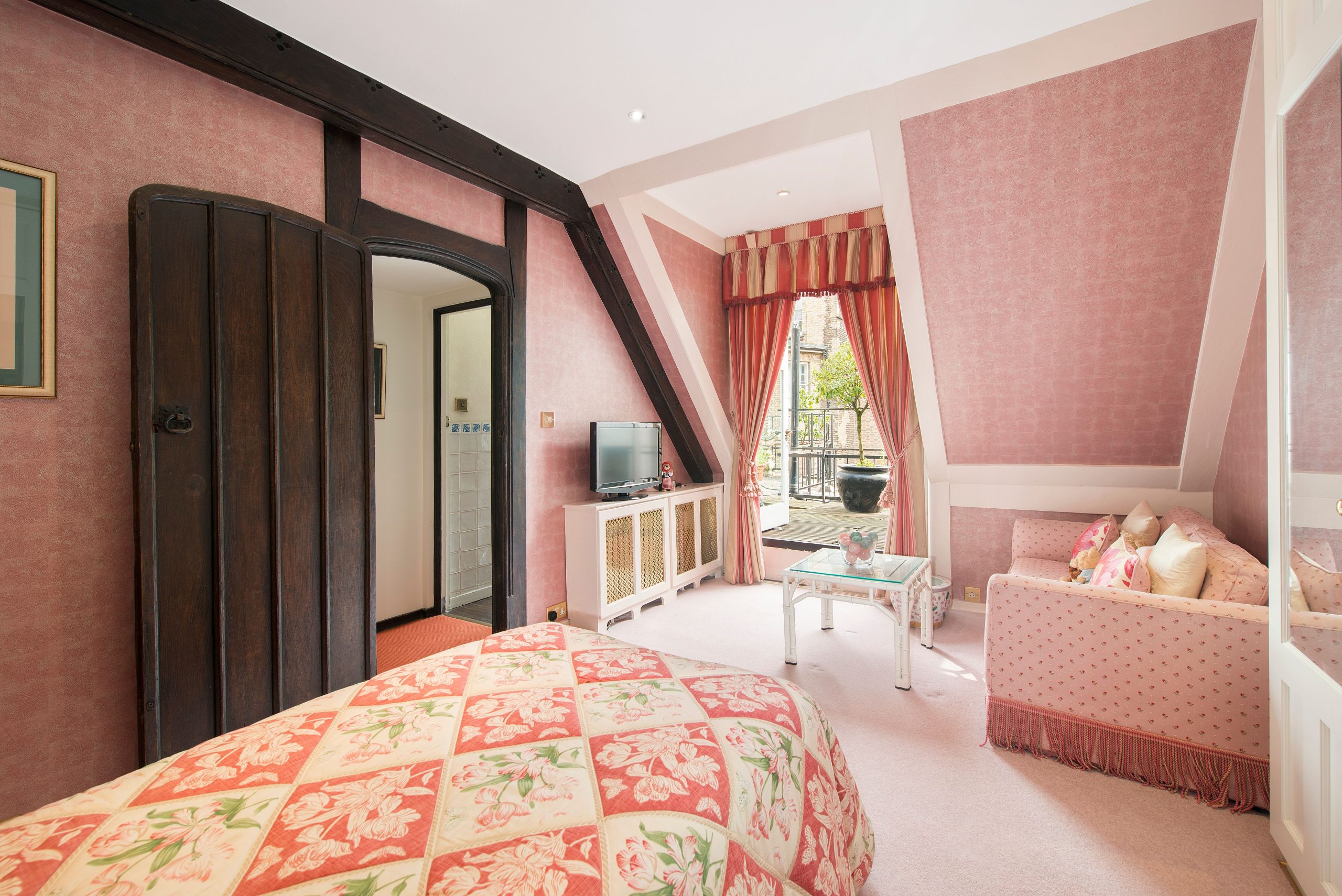 A pink bedroom in Farm House, Mayfair.