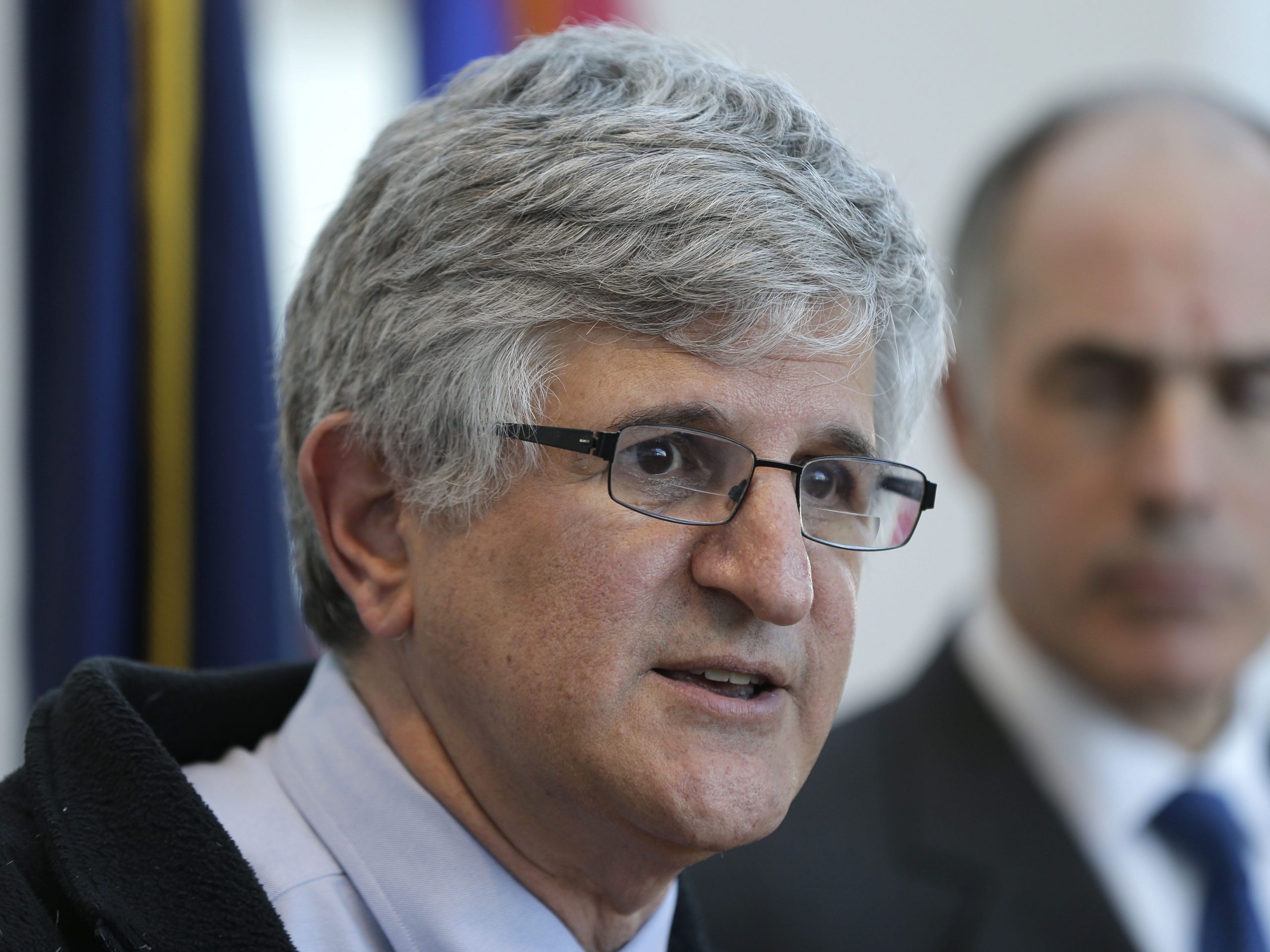Dr. Paul A. Offit speaks at a press conference while Pennsylvania Sen. Bob Casey Jr. looks on