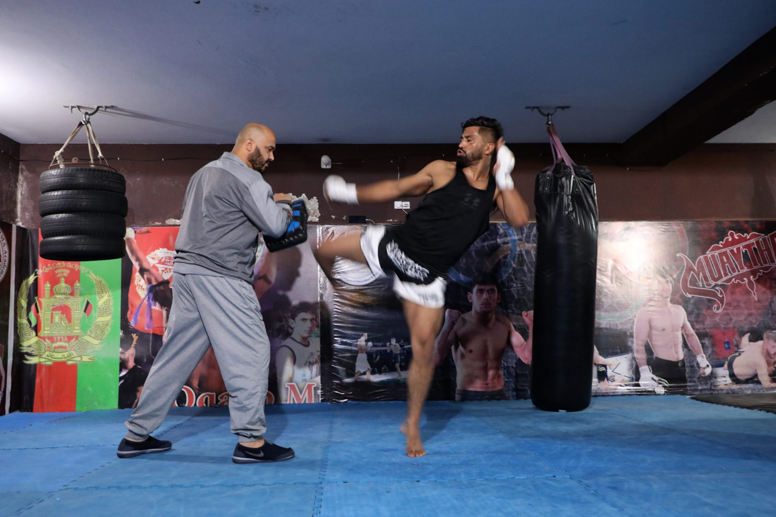 A man is seen landing a kick at his coach.