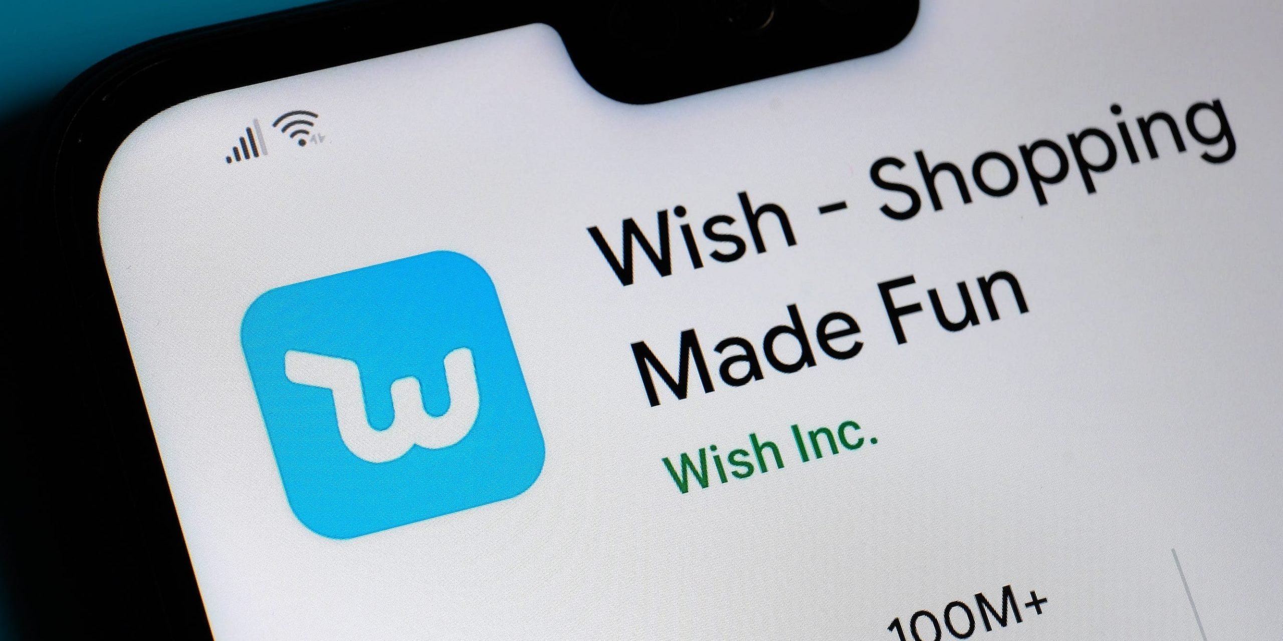 An Android phone showing the logo for the app Wish, along with the tagline "Wish - Shopping Made Fun."