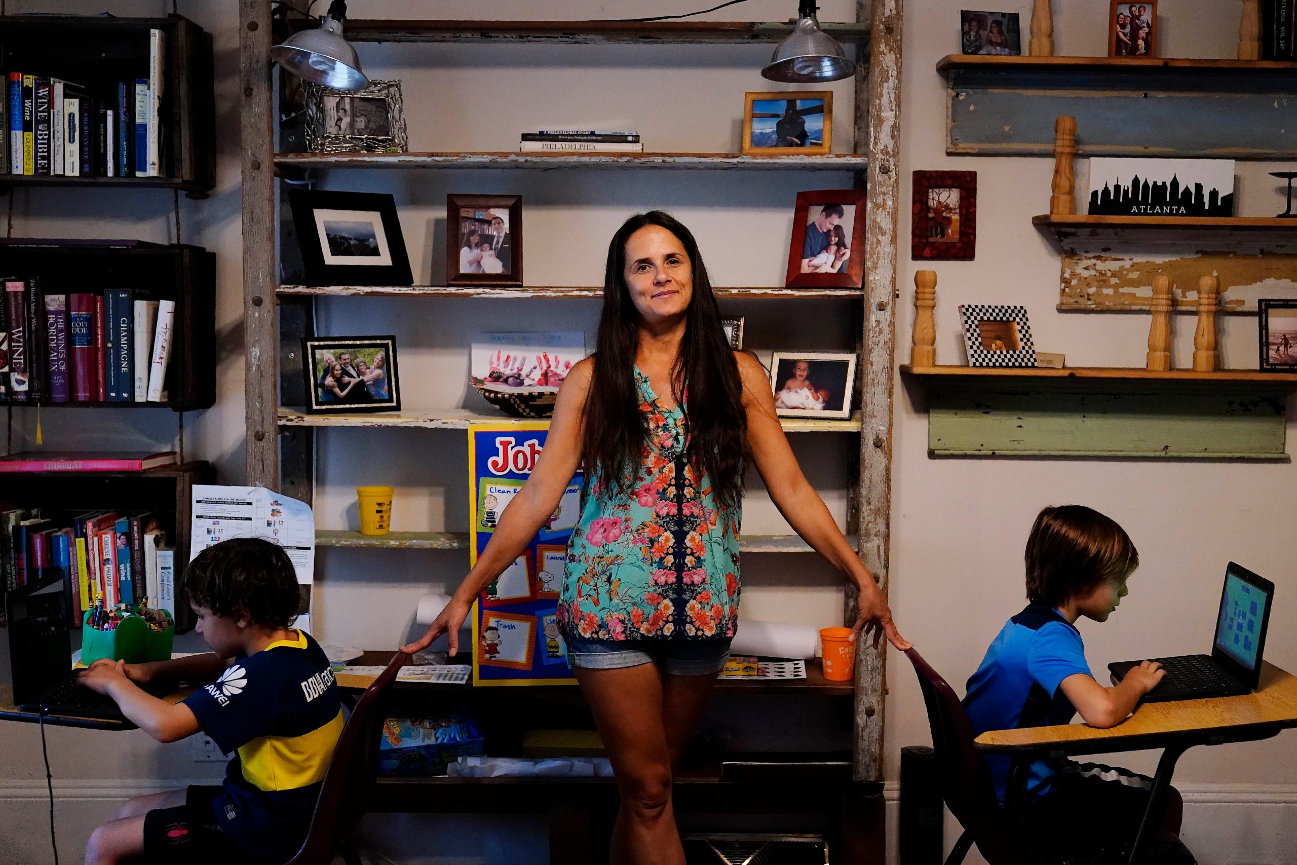 Anna Hamilton, 43, center, poses for a photograph with her sons, Henry, 6, left, and Adrian, 7, right, in their home.