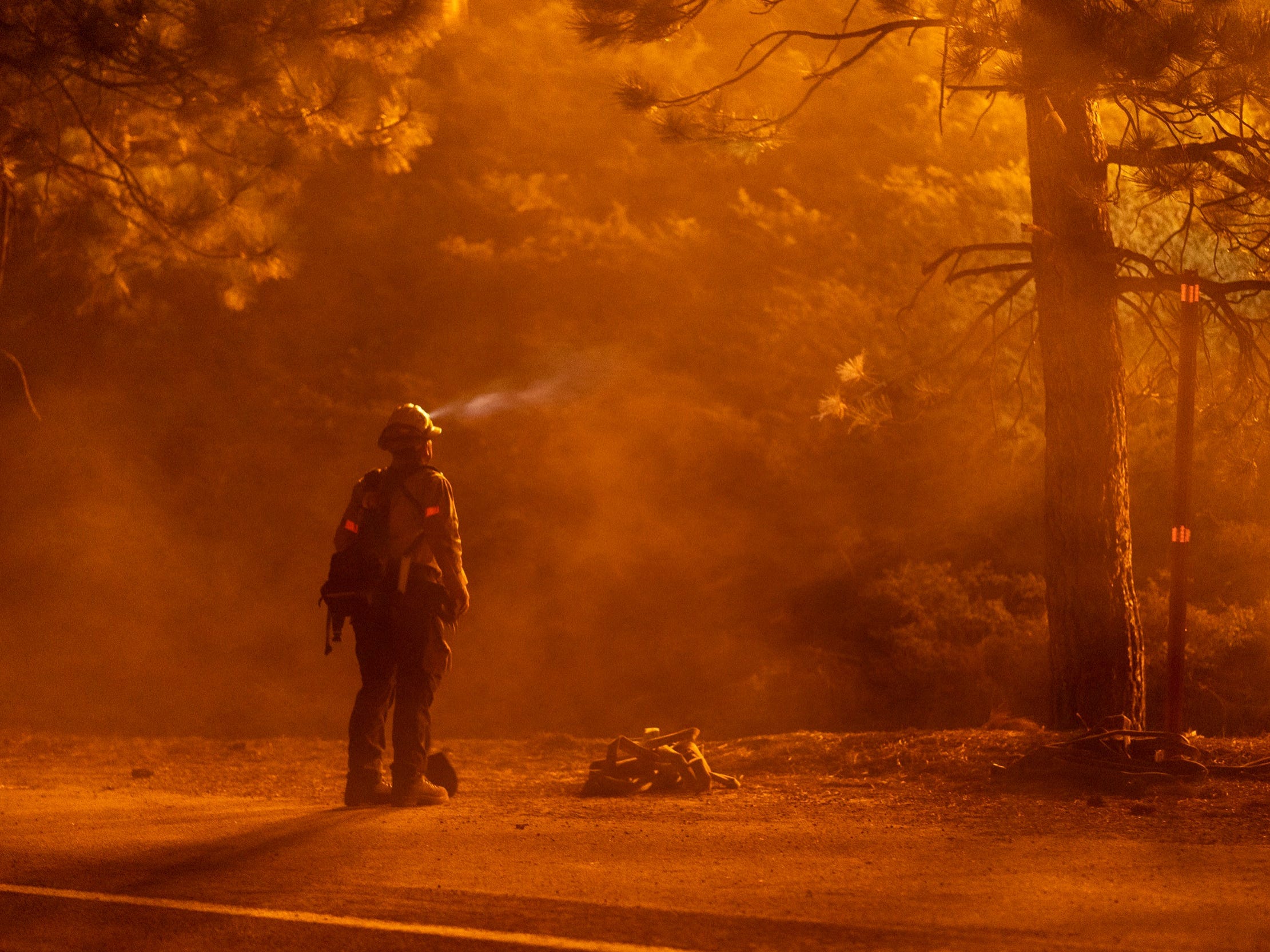 California firefighter works to put out wildfire