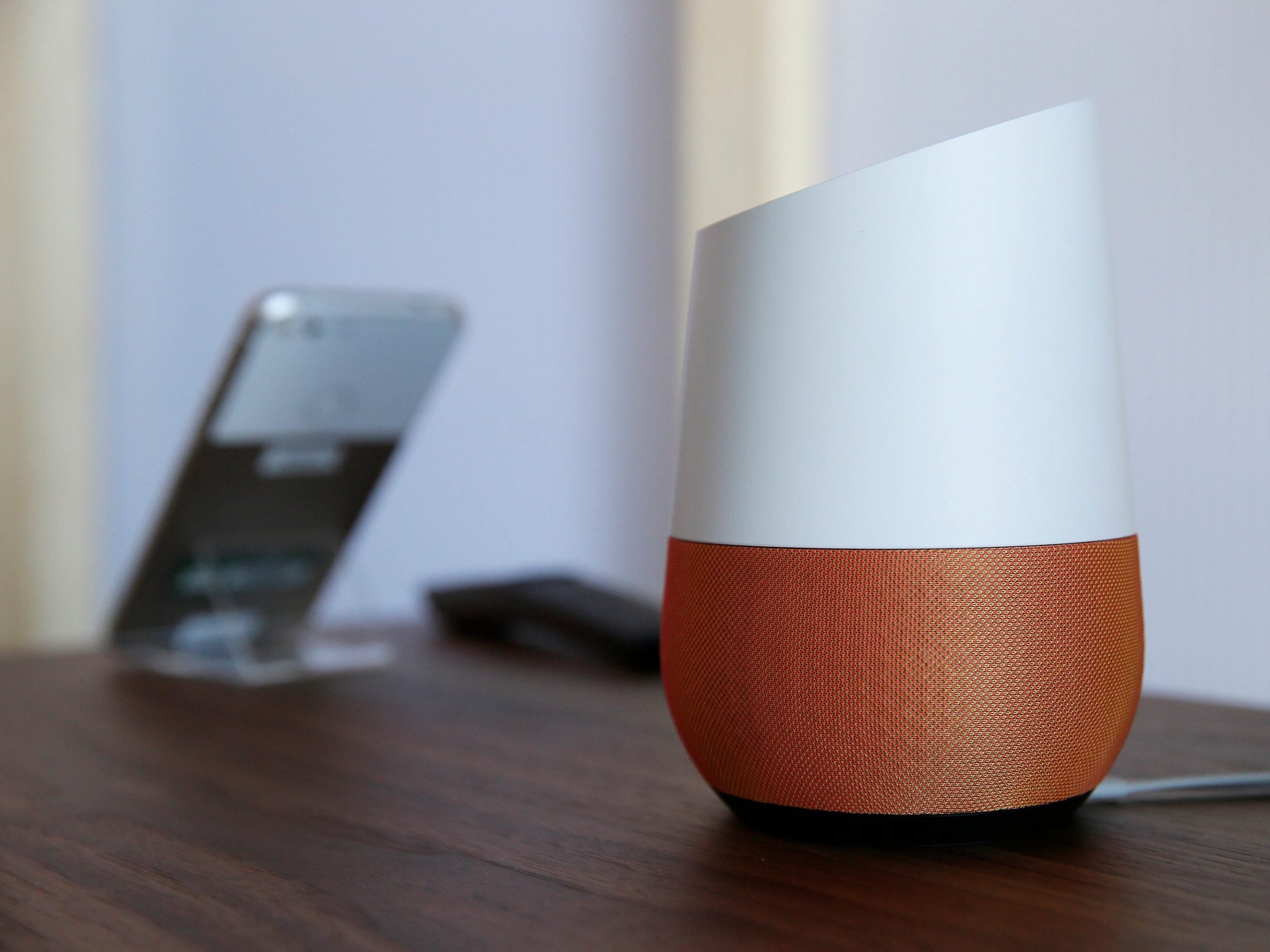 Google Home on a table next to a Google phone