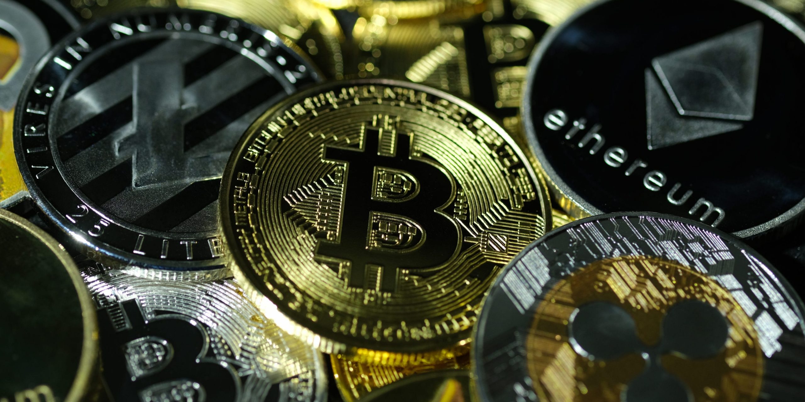 Photo illustration of visual representations of digital cryptocurrencies