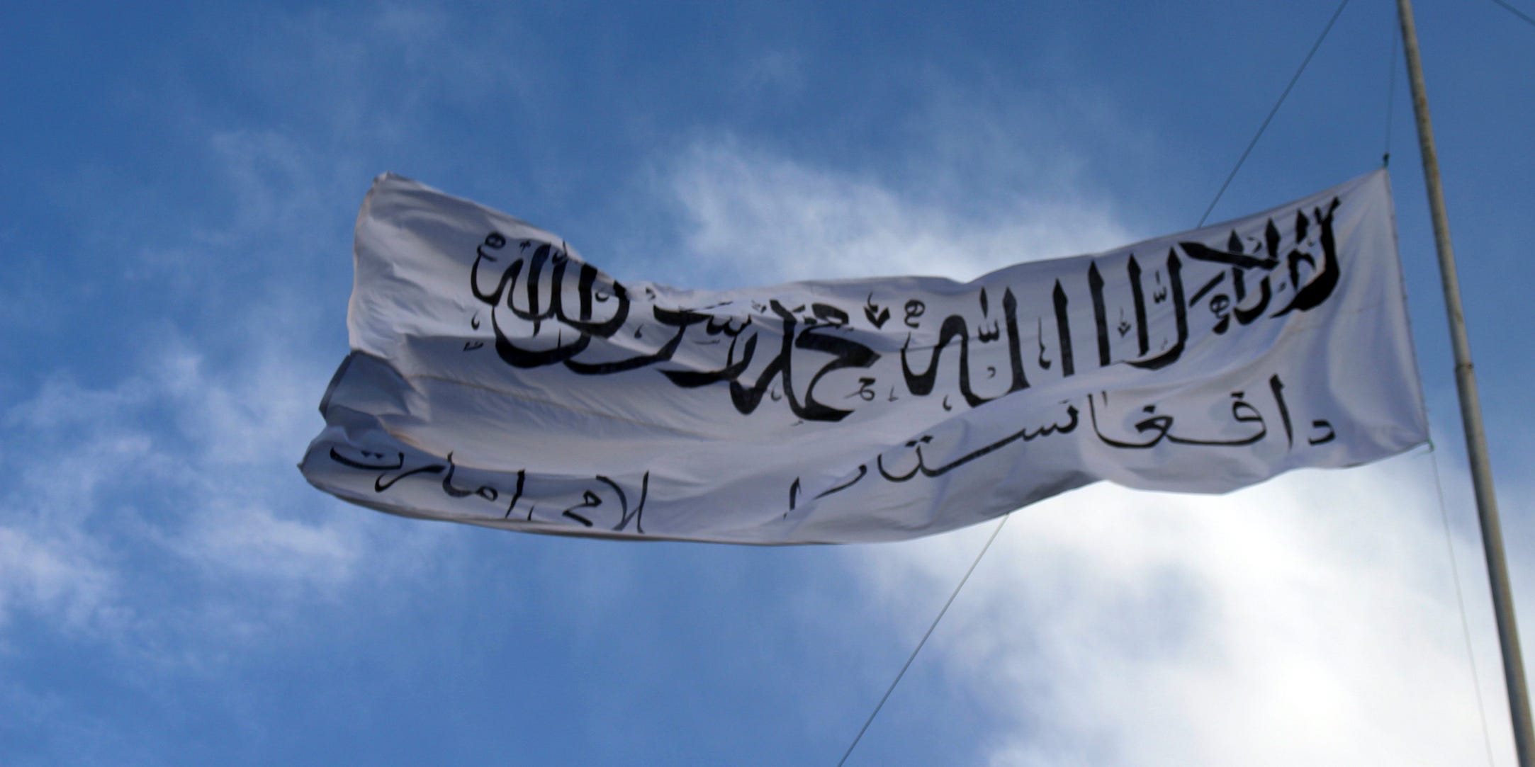 The white Taliban flag flies at the Ghazni provincial governor's house, in Ghazni, southeastern, Afghanistan, Sunday, Aug. 15, 2021.