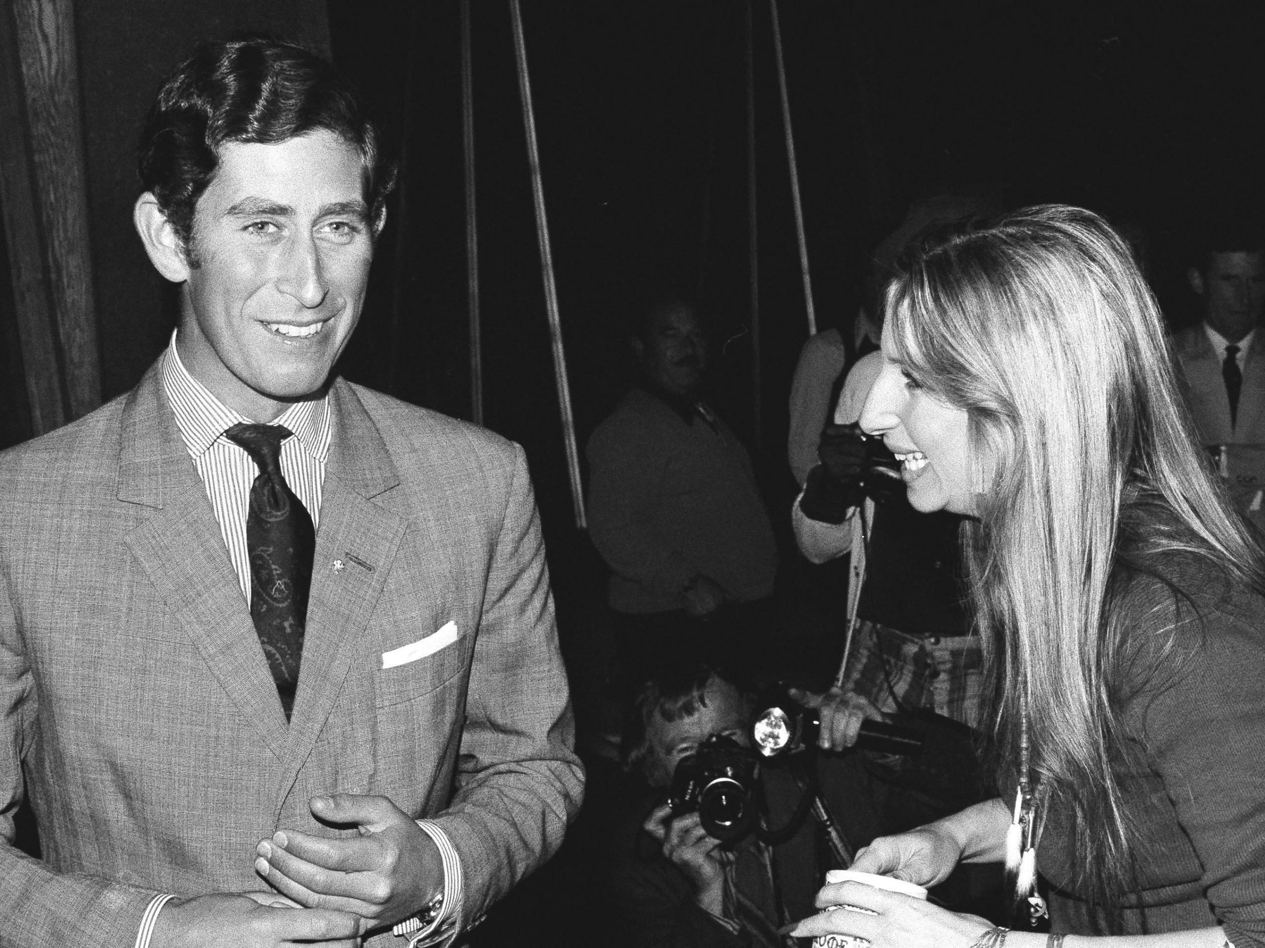 U.S. actress and singer Barbra Streisand offers a cup of coffee to Prince Charles as they chat on a set at Warner Bros. studio in Los Angeles, CA, March. 19, 1974.