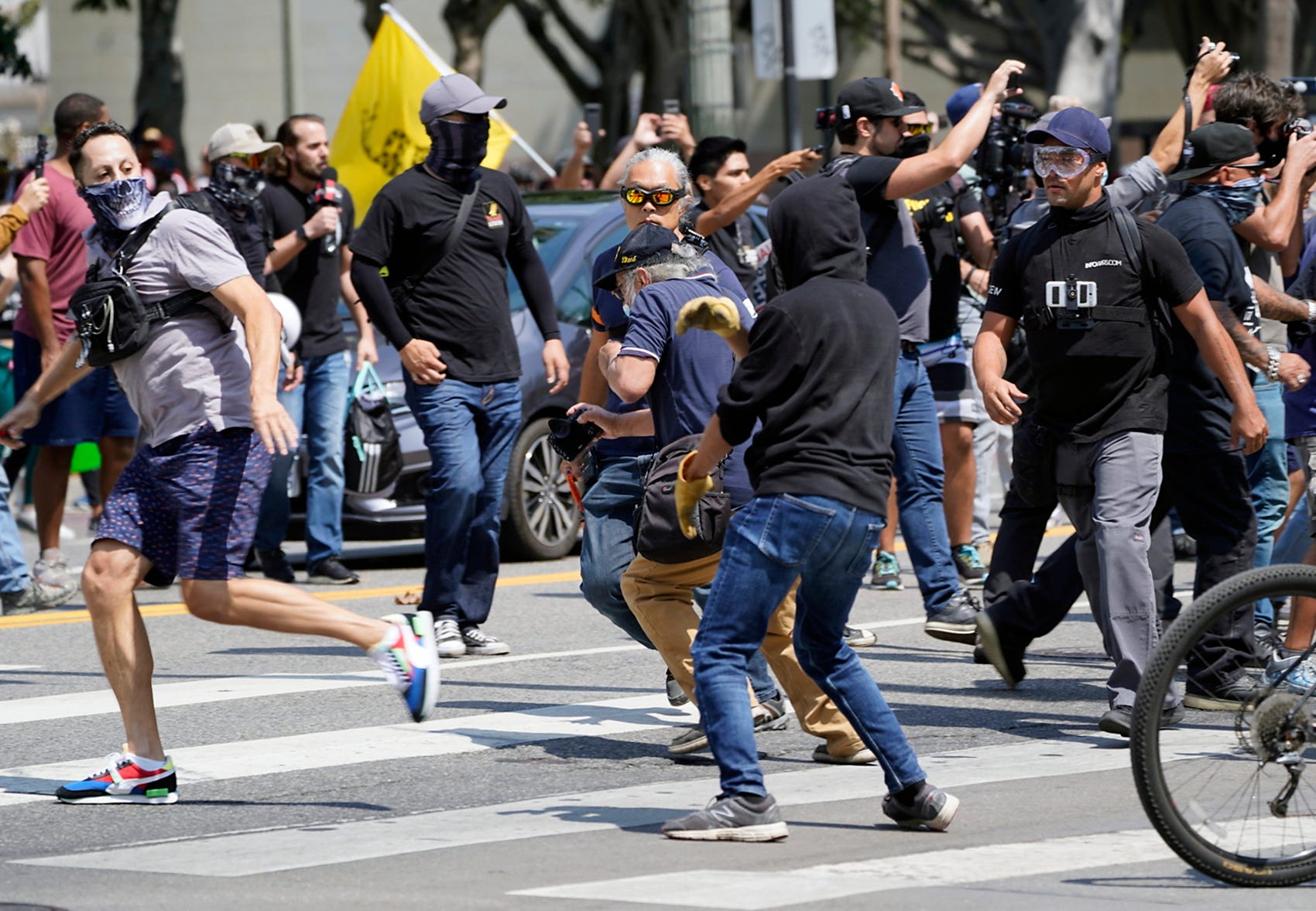 Anti-vaccine protesters and counter protesters clash during protest in front of La's City Hall on Saturday.