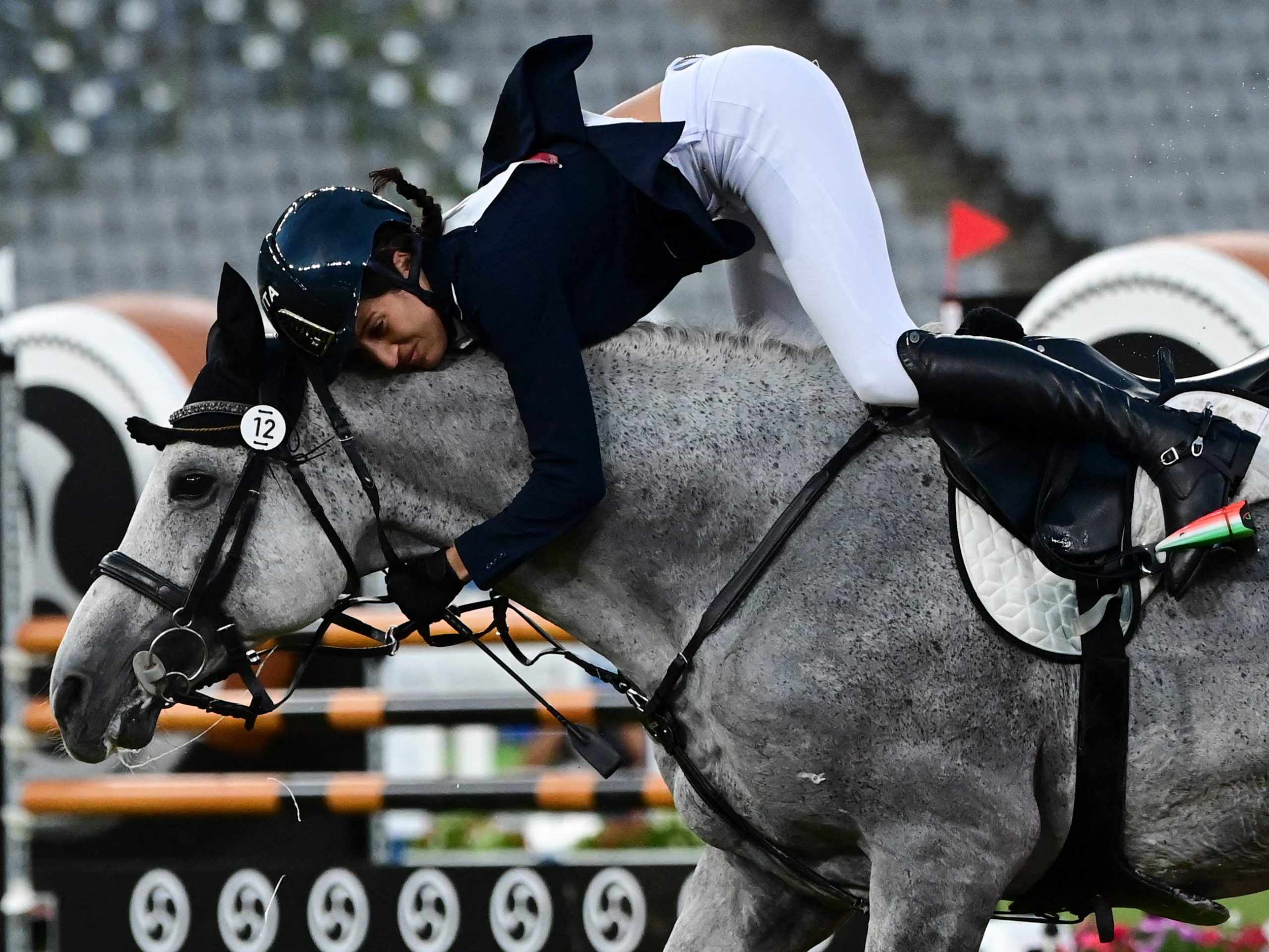 Elena Micheli of Italy is bucked from her horse during the showjumping portion of the Olympic modern pentathlon