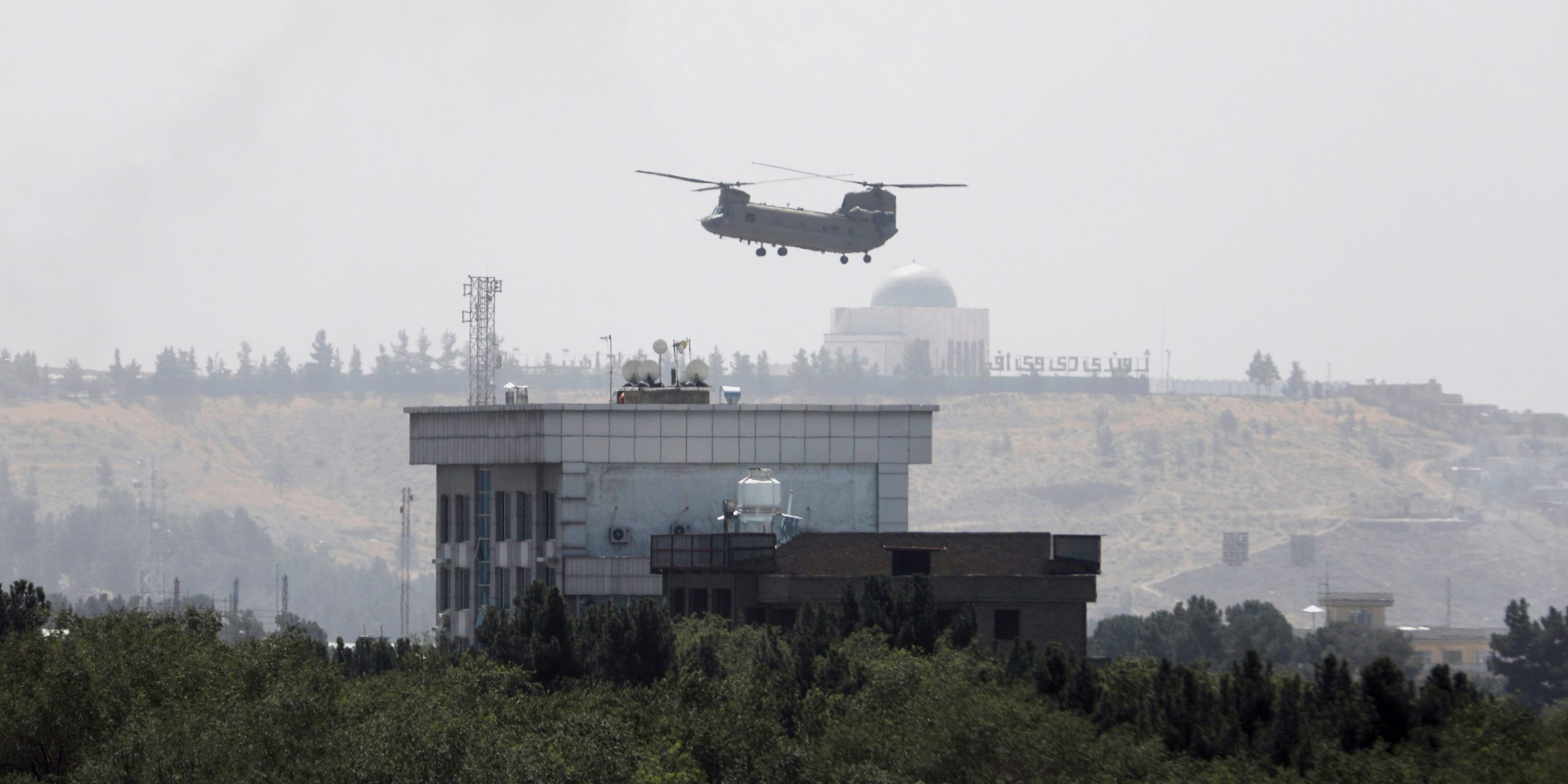A U.S. Chinook helicopter flies near the U.S. Embassy in Kabul, Afghanistan, Sunday, Aug. 15, 2021.