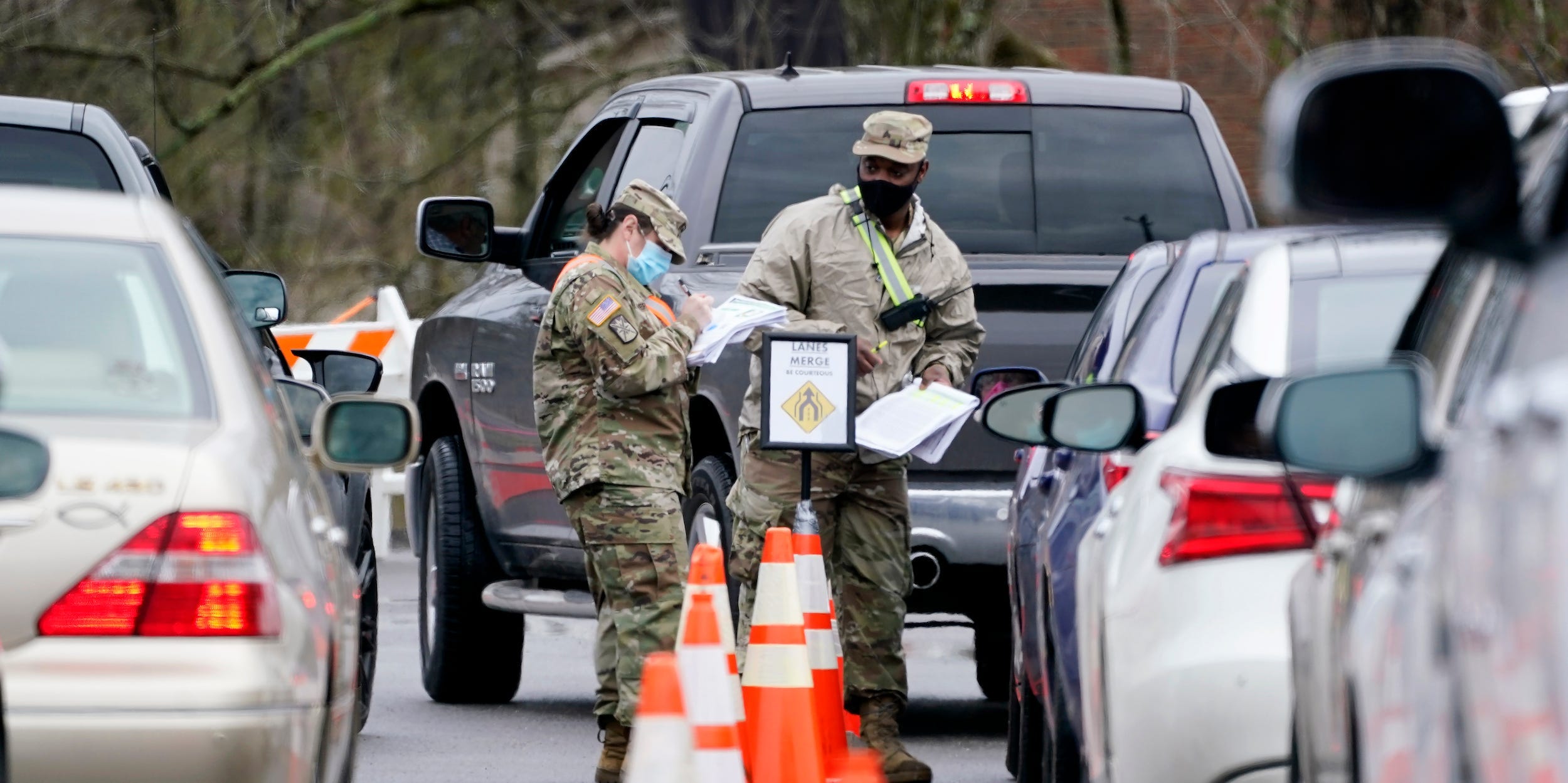 National Guard personnel check in people as they wait to receive a COVID-19 vaccination Feb. 26, 2021, in Shelbyville, Tennessee.