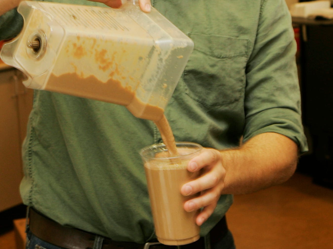 pouring coffee into plastic cup