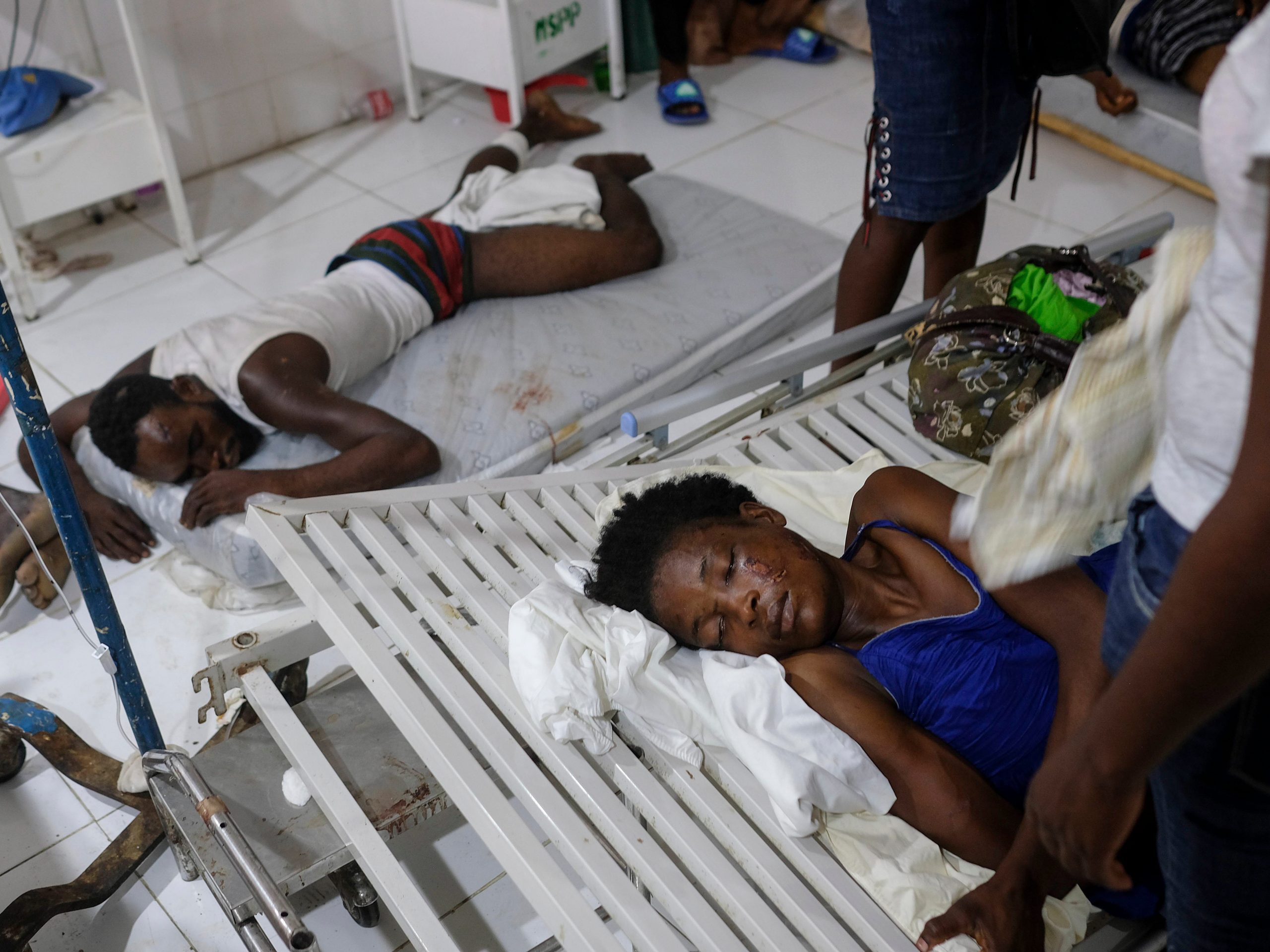 Injured people lie in the Immaculée Conception hospital in Les Cayes, Haiti, Monday, Aug. 16, 2021, two days after a 7.2-magnitude earthquake struck the southwestern part of the country.