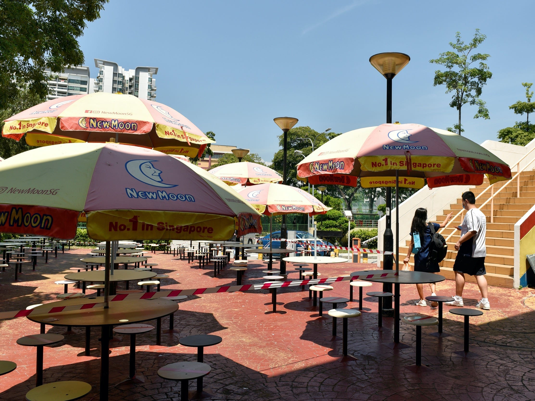 a hawker center in singapore with seating blocked off
