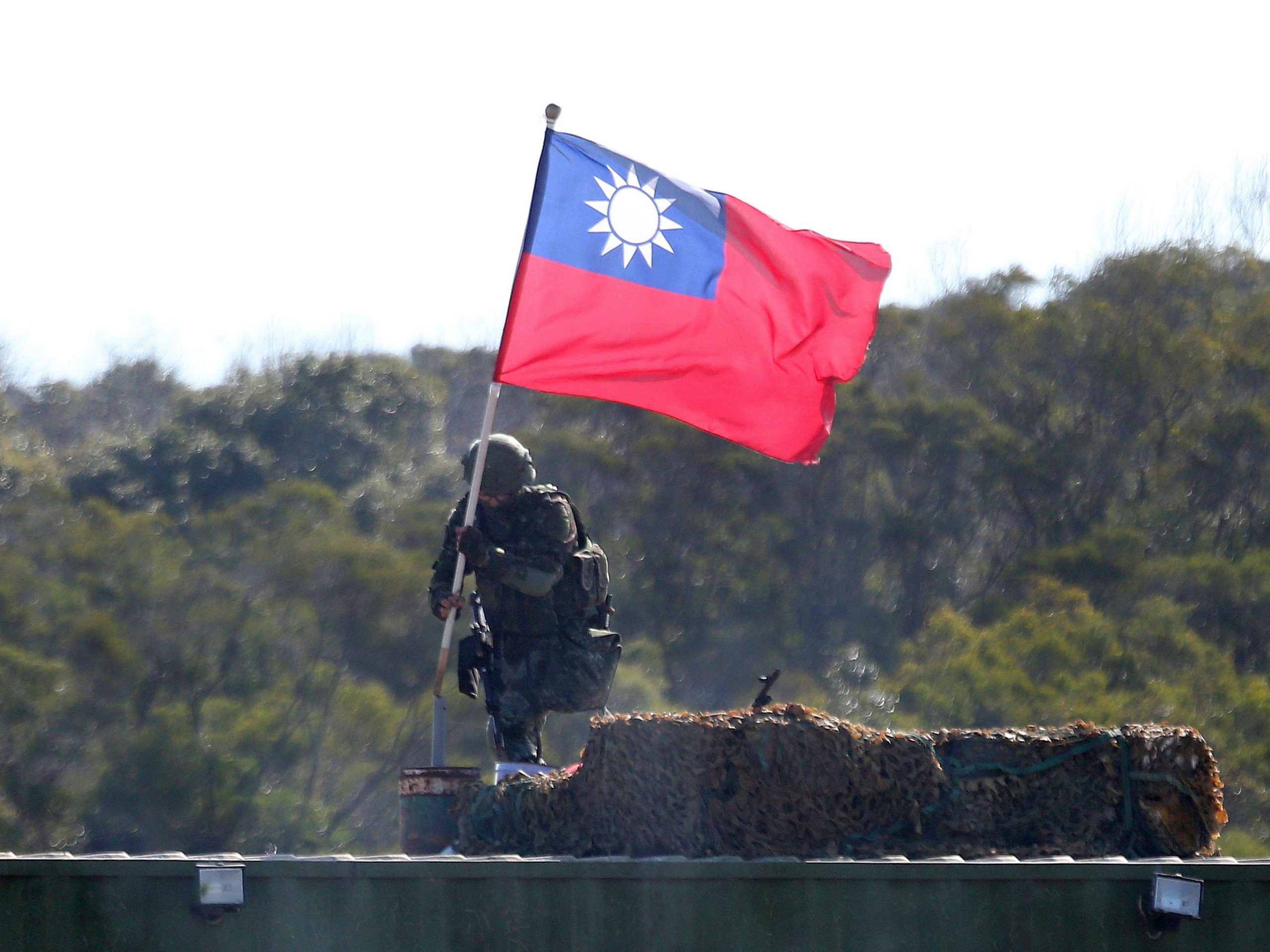 A soldier holds a Taiwanese flag during a military exercise aimed at repelling an attack from China in Hsinchu County, northern Taiwan, January 19, 2021.