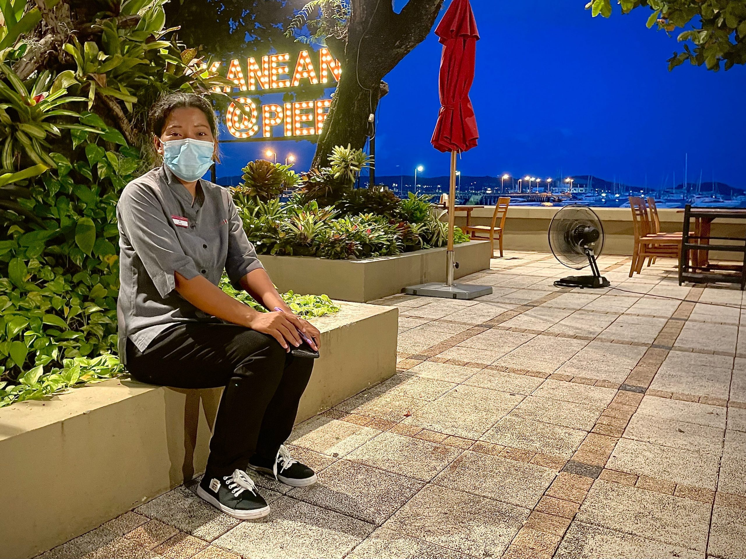 Kan Eang Pier waitress Saowanee Sittirak sits at the popular Rawai Beach seafood restaurant situated in the southern end of Phuket, Thailand, Aug. 11, 2021.