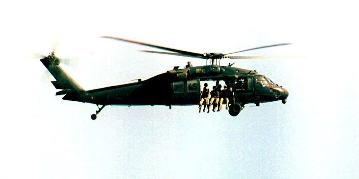 US troops in a Black Hawk helicopter over Mogadishu, Somalia