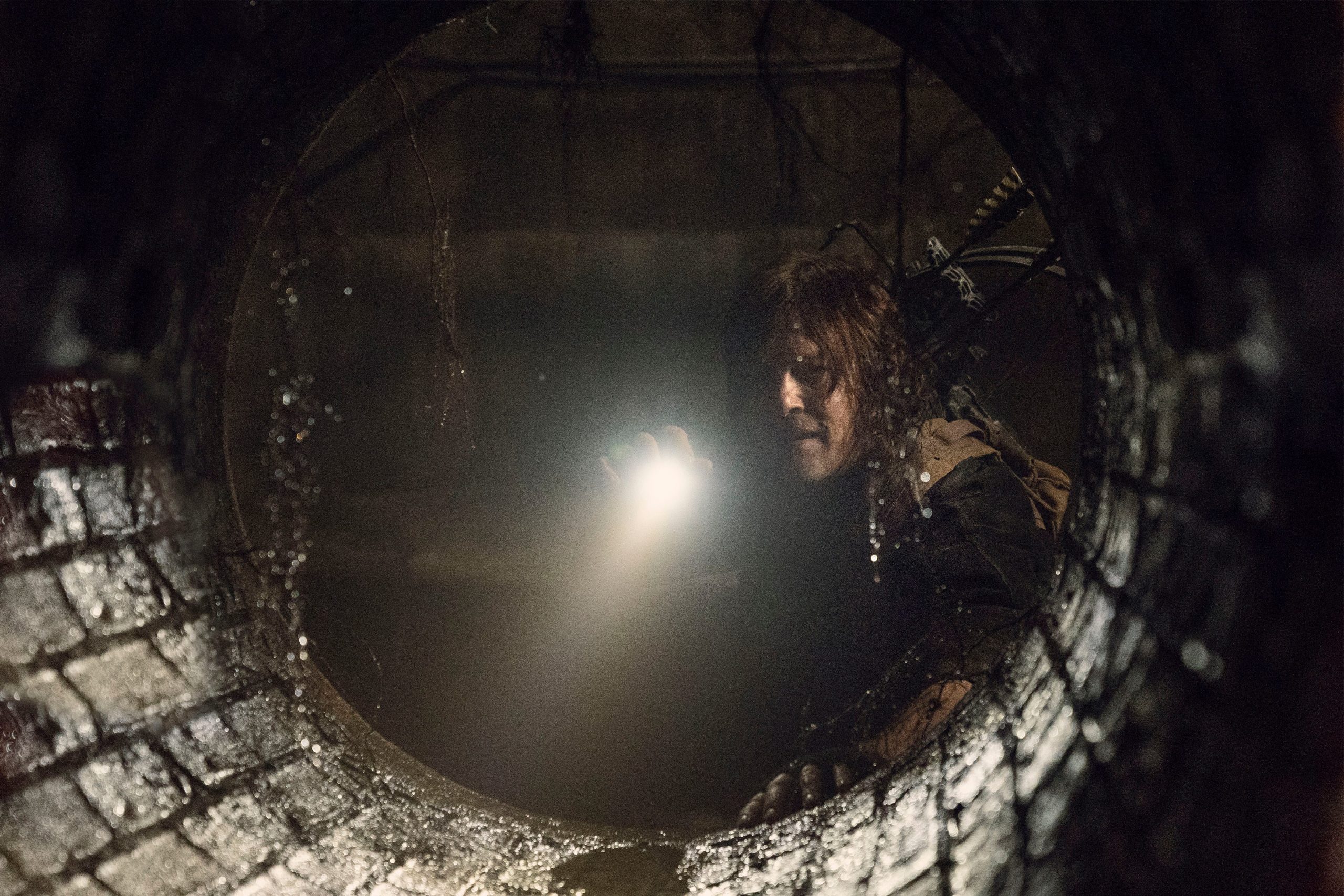 TWD 1102 Daryl Dixon looks in a tunnel for Dog