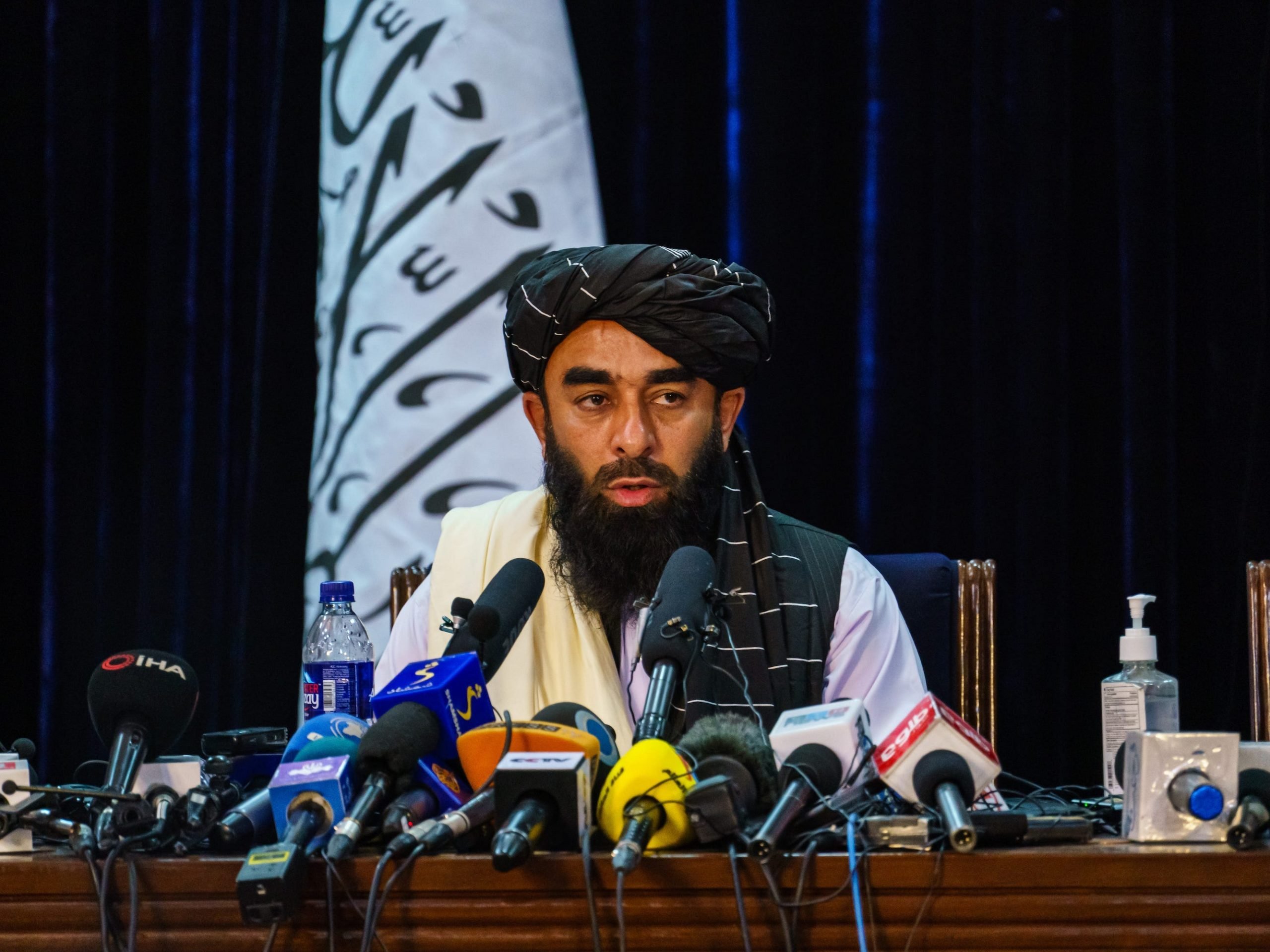 Taliban spokesman Zabihullah Mujahid makes his first-ever public appearance at a press conference.
