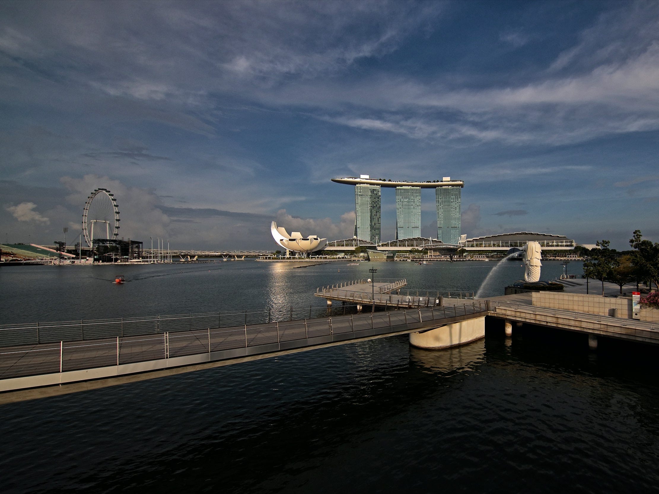 view of the Singapore Flyer, Marina Bay Sands, an empty Merlion Park and an empty bridge in singapore