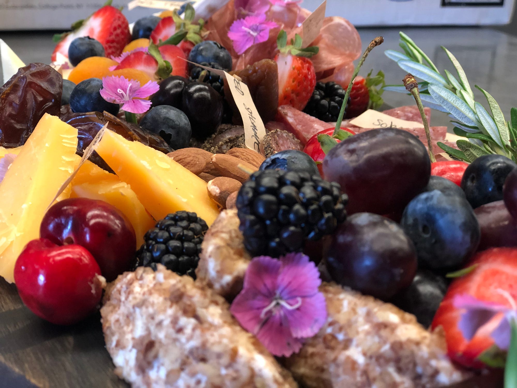 Flowers on a charcuterie board.