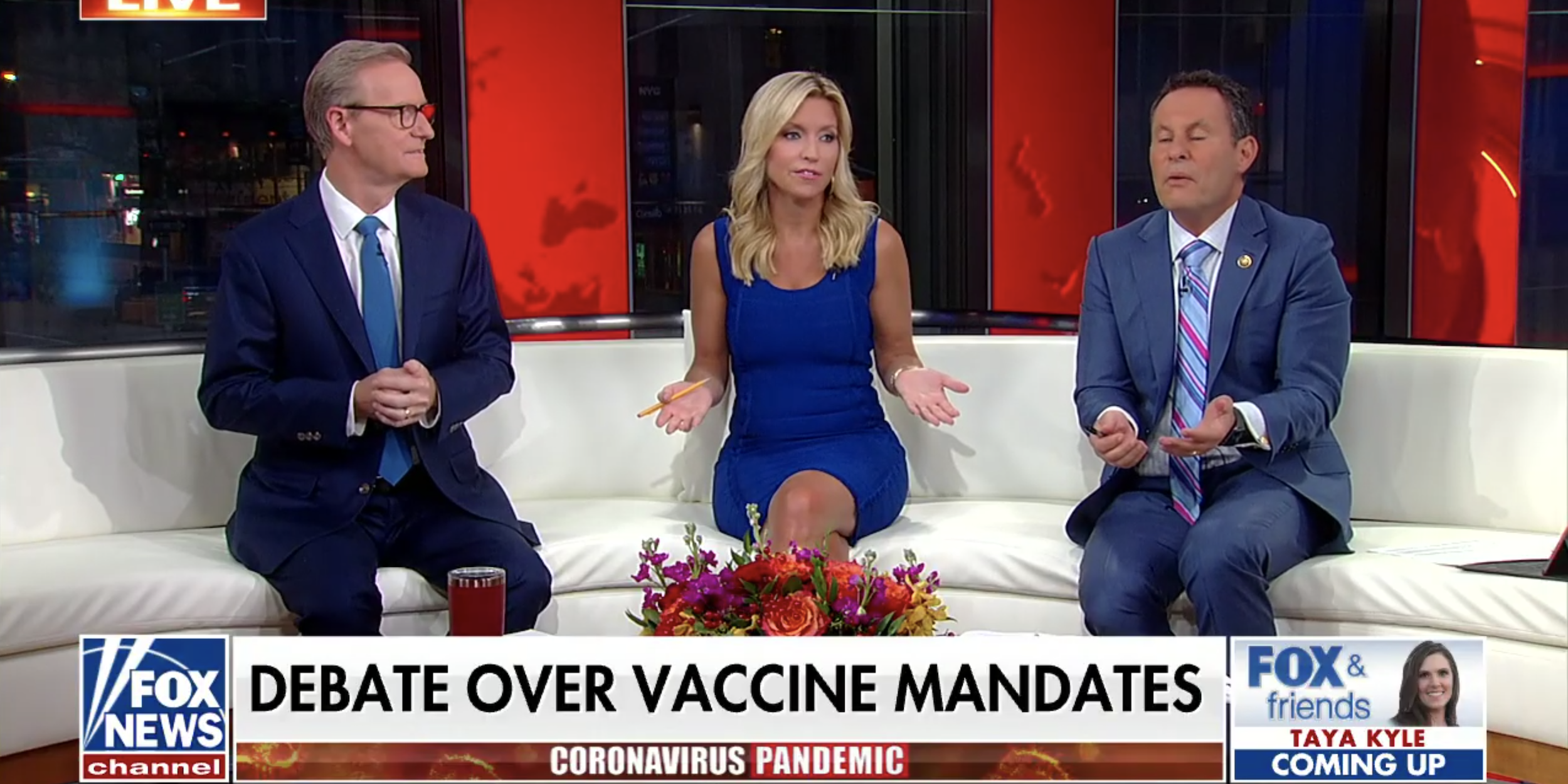 Fox & Friends hosts discuss COVID-19 vaccination on their New York City set on Wednesday.