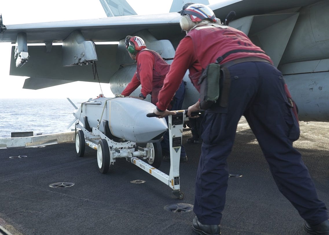 US Navy sailors prepare weapons for a SINKEX