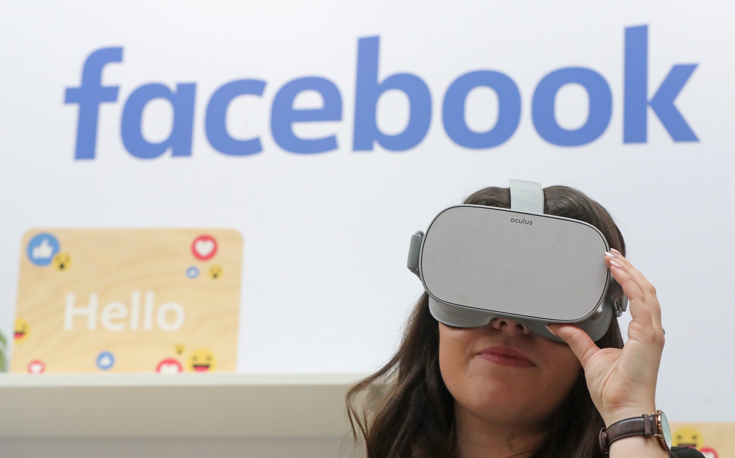 A woman uses an Oculus virtual reality headset at the Facebook stand during the Dublin Tech Summit.