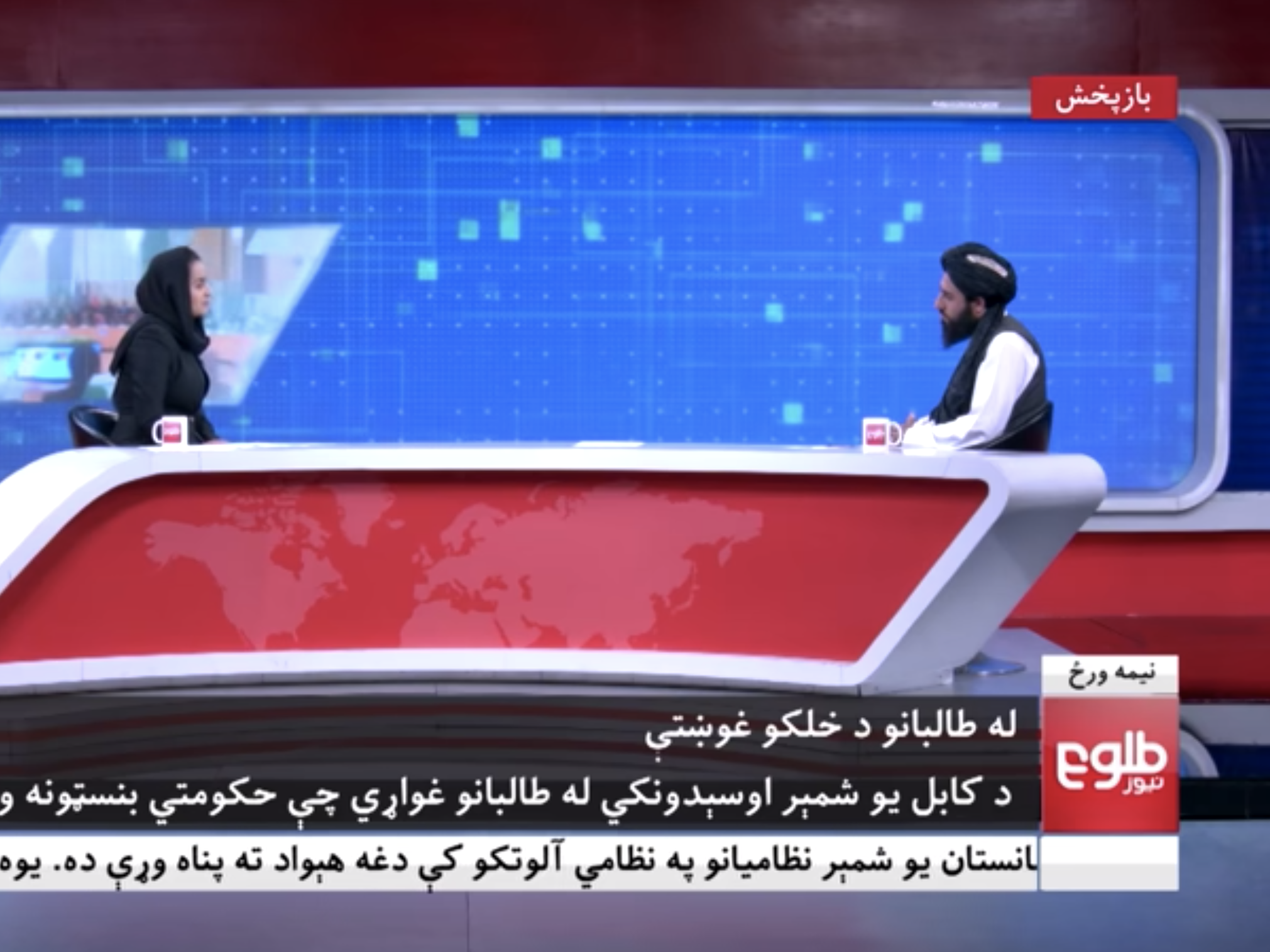 A female TOLO News reporter interviews a Taliban official on Tuesday.
